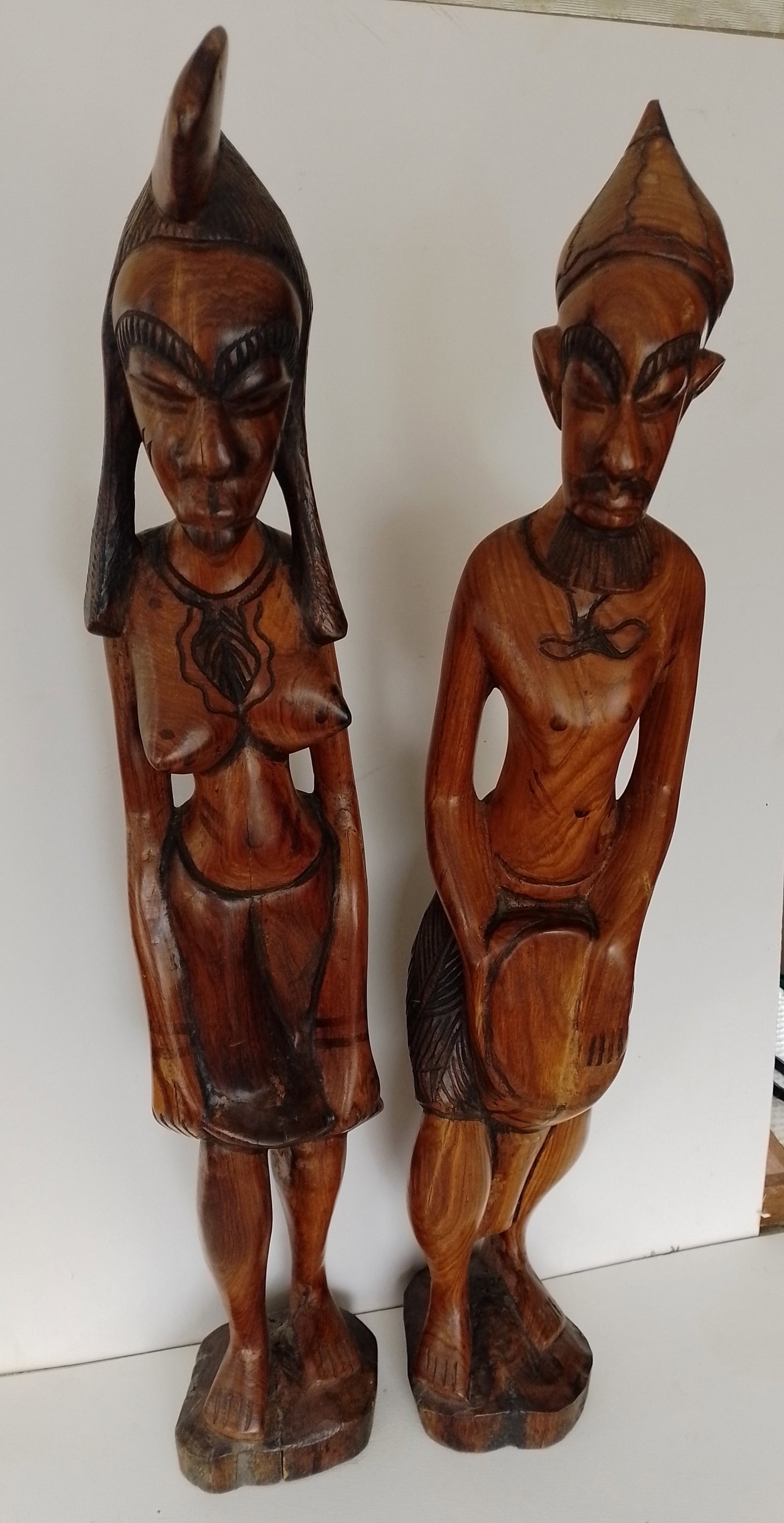 African Hardwood Satues: Title: African Hardwood Satues Description: 2 large and heavy African hardwood statues of a man and women with great detail. Both figures are approx 64cm tall. The bases are approx 10cm wide.