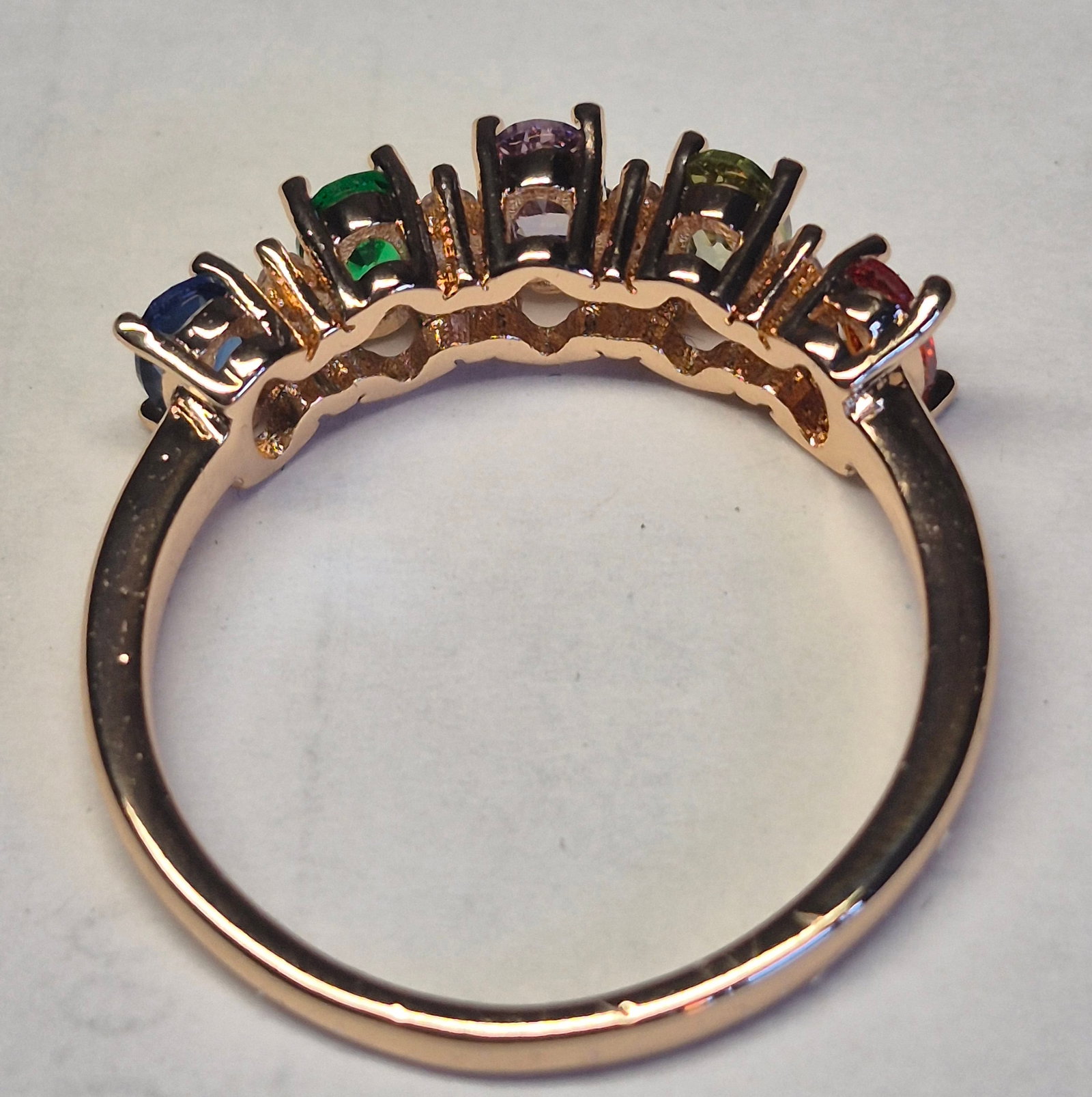 Rainbow Gemstone Ring – Multi Colour Oval Gemstones In Rose Gold Tone: Title: Rainbow Gemstone Ring – Multi Colour Oval Gemstones In Rose Gold Tone Description: Elegant rainbow-inspired ring featuring five vibrant oval-cut gemstones in a stunning spectrum of