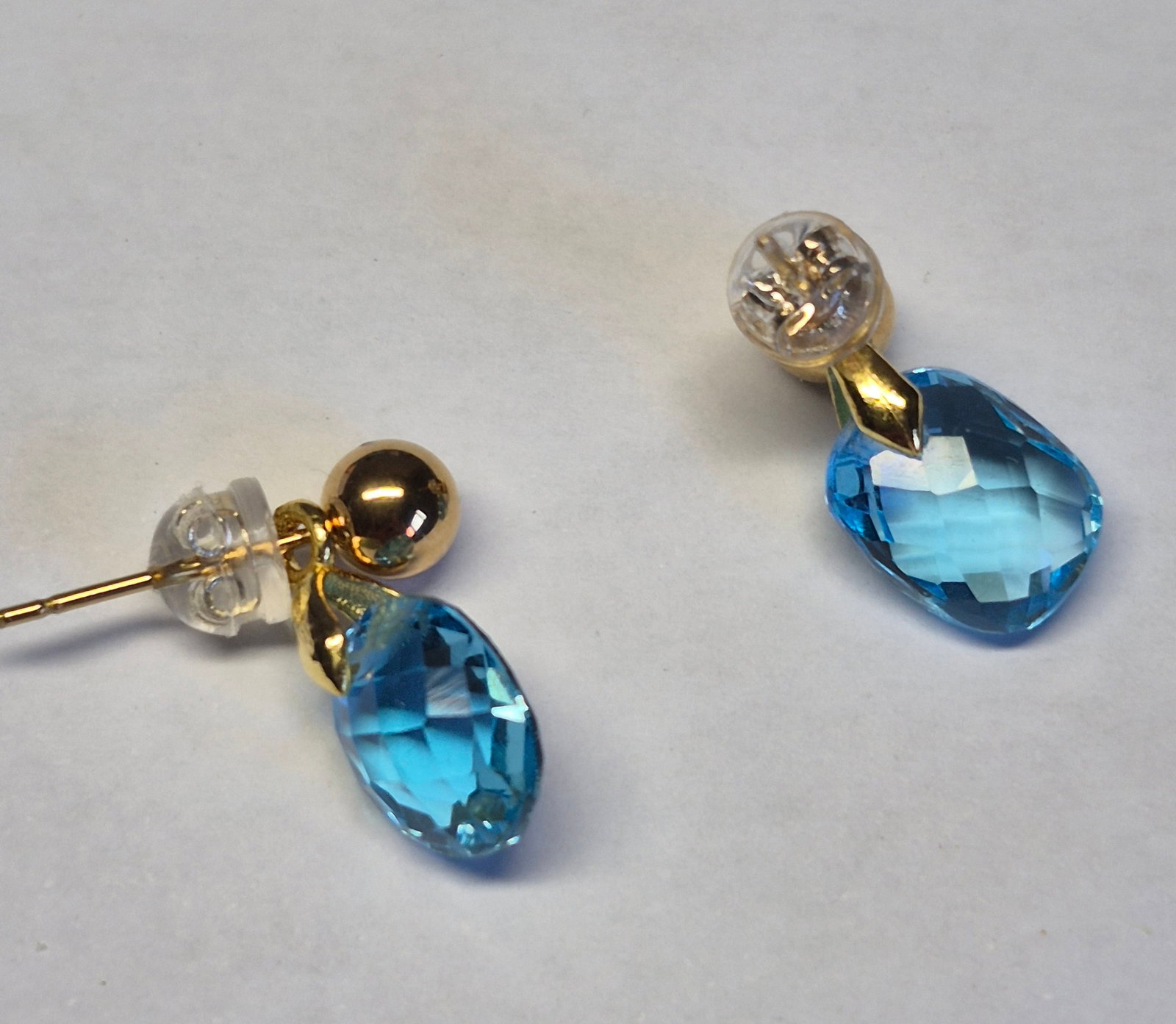 Natural Swiss Blue Topaz Drop Earrings – 10x8 mm Faceted Gemstones, Gold Tone Stud Design: Title: Natural Swiss Blue Topaz Drop Earrings – 10x8 mm Faceted Gemstones, Gold Tone Stud Design Description: Elegant pair of earrings featuring natural Swiss Blue Topaz gemstones in a