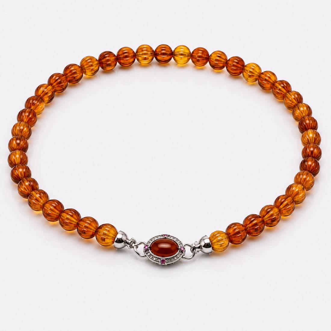 Natural Baltic Amber Necklace With Decorative Carnelian Clasp: Title: Natural Baltic Amber Necklace With Decorative Carnelian Clasp Description: Beautiful necklace crafted from warm honey and cognac-coloured natural amber beads, displaying excellent transparency
