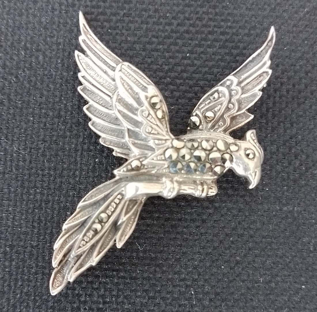 Silver Flying Bird Brooch With Marcasite Stones: Title: Silver Flying Bird Brooch With Marcasite Stones Description: Silver Flying bird with marcasite stones. Approx 3.5cm wide and 5cm long. Condition: Used Delivery option: Collection &