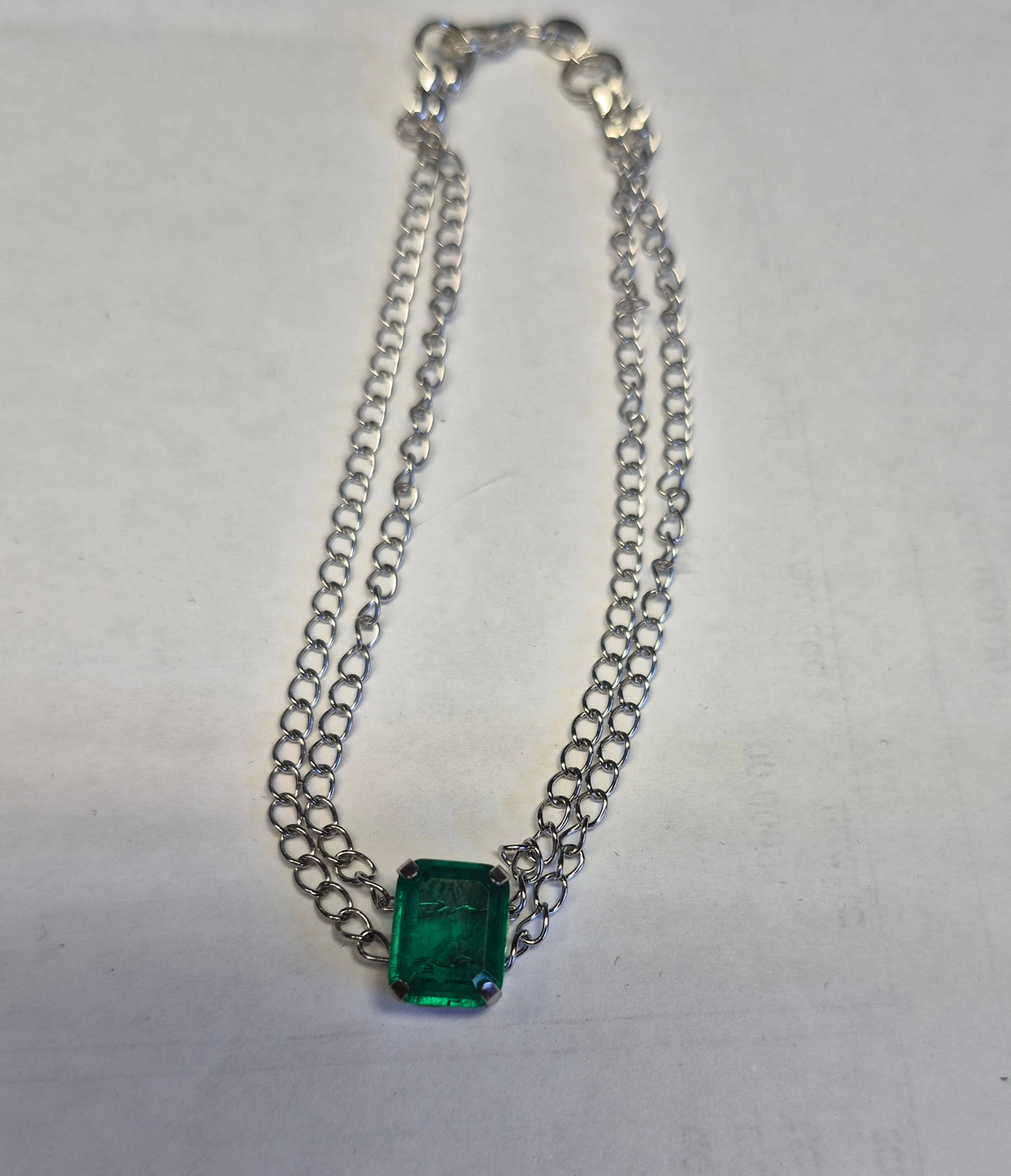 Natural Emerald Doublet Double Chain Bracelet – Emerald Cut Green Stone – Stainless Stee: Title: Natural Emerald Doublet Double Chain Bracelet – Emerald Cut Green Stone – Stainless Steel – 19 cm Description: Elegant double-chain bracelet crafted from stainless steel and