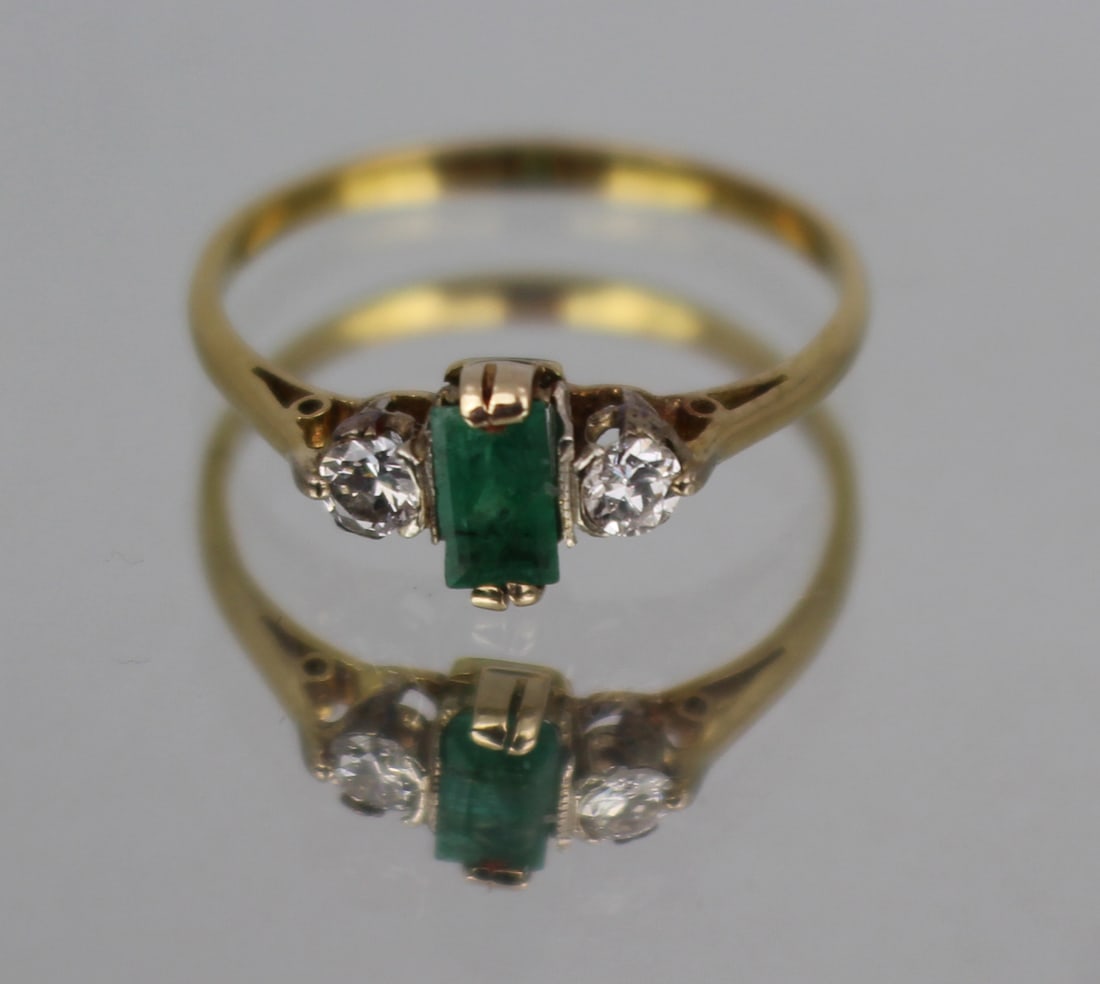 Vintage Emerald and Diamond Ring: Title: Vintage Emerald and Diamond Ring Description: Vintage Emerald and Diamond Ring Material: 9ct Yellow Gold Center Stone: Emerald, Emerald Cut (approximately 0.5 carats) Side Stones: Two Round