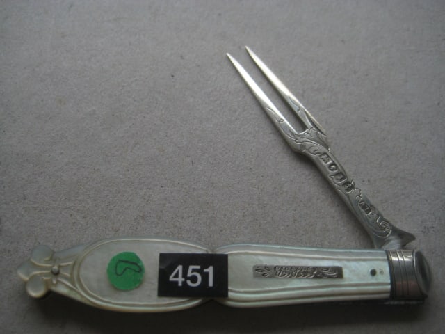 Victorian Mother of Pearl Hafted Silver Bladed Folding Fruit Fork: Title: Victorian Mother of Pearl Hafted Silver Bladed Folding Fruit Fork Description: Victorian Mother of Pearl Hafted Silver Bladed Folding Fruit Fork. The handle is carved into a