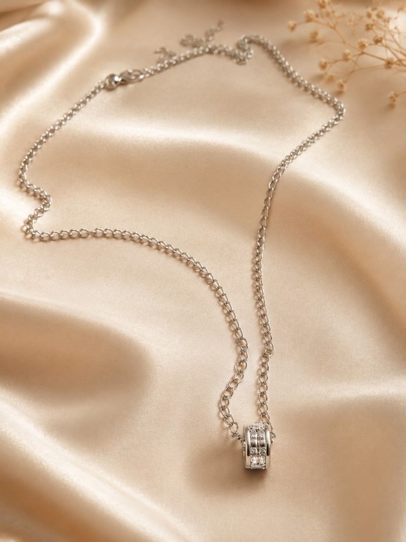 Stainless Steel Crystal Pendant Necklace With 925 Silver Clasp: Title: Stainless Steel Crystal Pendant Necklace With 925 Silver Clasp Description: Elegant stainless steel necklace featuring a modern circular pendant accented with sparkling clear crystals. 