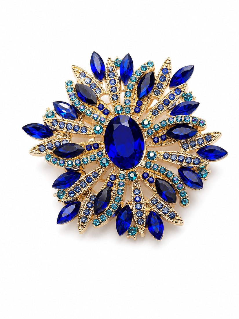 Vintage Blue Crystal Statement Brooch – Gold Tone Floral Design: Title: Vintage Blue Crystal Statement Brooch – Gold Tone Floral Design Description: Elegant vintage-style statement brooch featuring a striking oval blue crystal centrepiece surrounded by