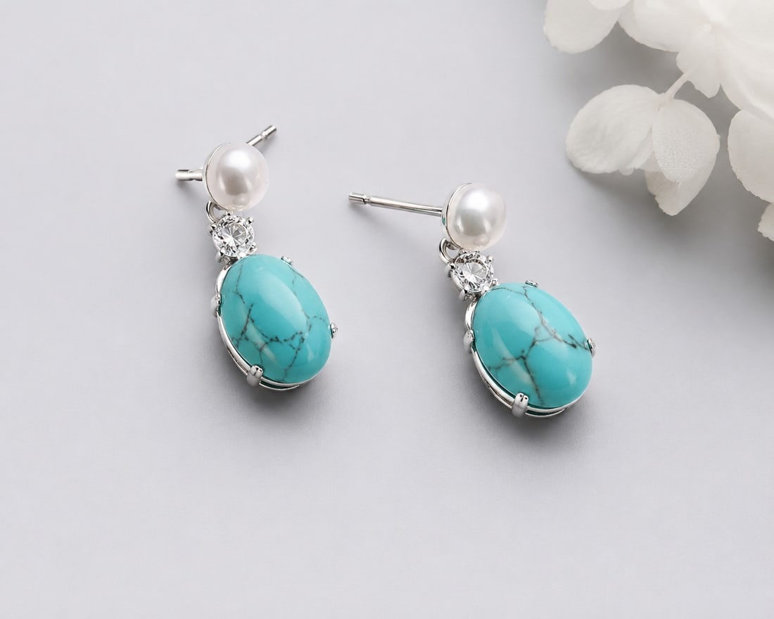 925 Sterling Silver Turquoise & Pearl Drop Earrings: Title: 925 Sterling Silver Turquoise & Pearl Drop Earrings Description: Elegant handcrafted drop earrings made from genuine 925 sterling silver, featuring oval turquoise stones accented with