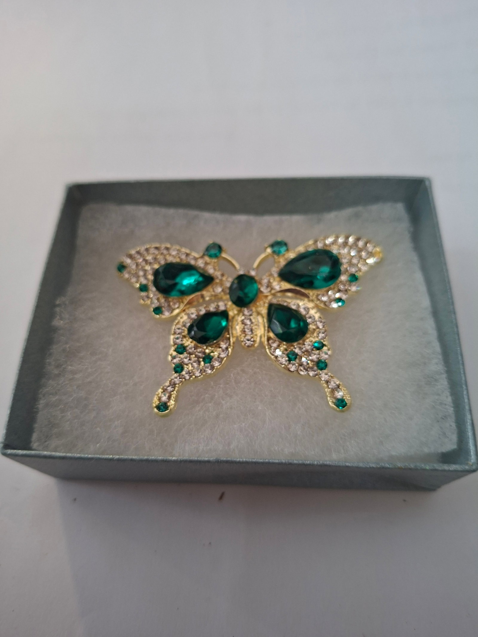Beautiful Emerald and Crystal Butterfly Brooch: Title: Beautiful Emerald and Crystal Butterfly Brooch Description: Gorgeous emerald green butterfly brooch. Very sparkly emerald and crystal stones. Complete with box