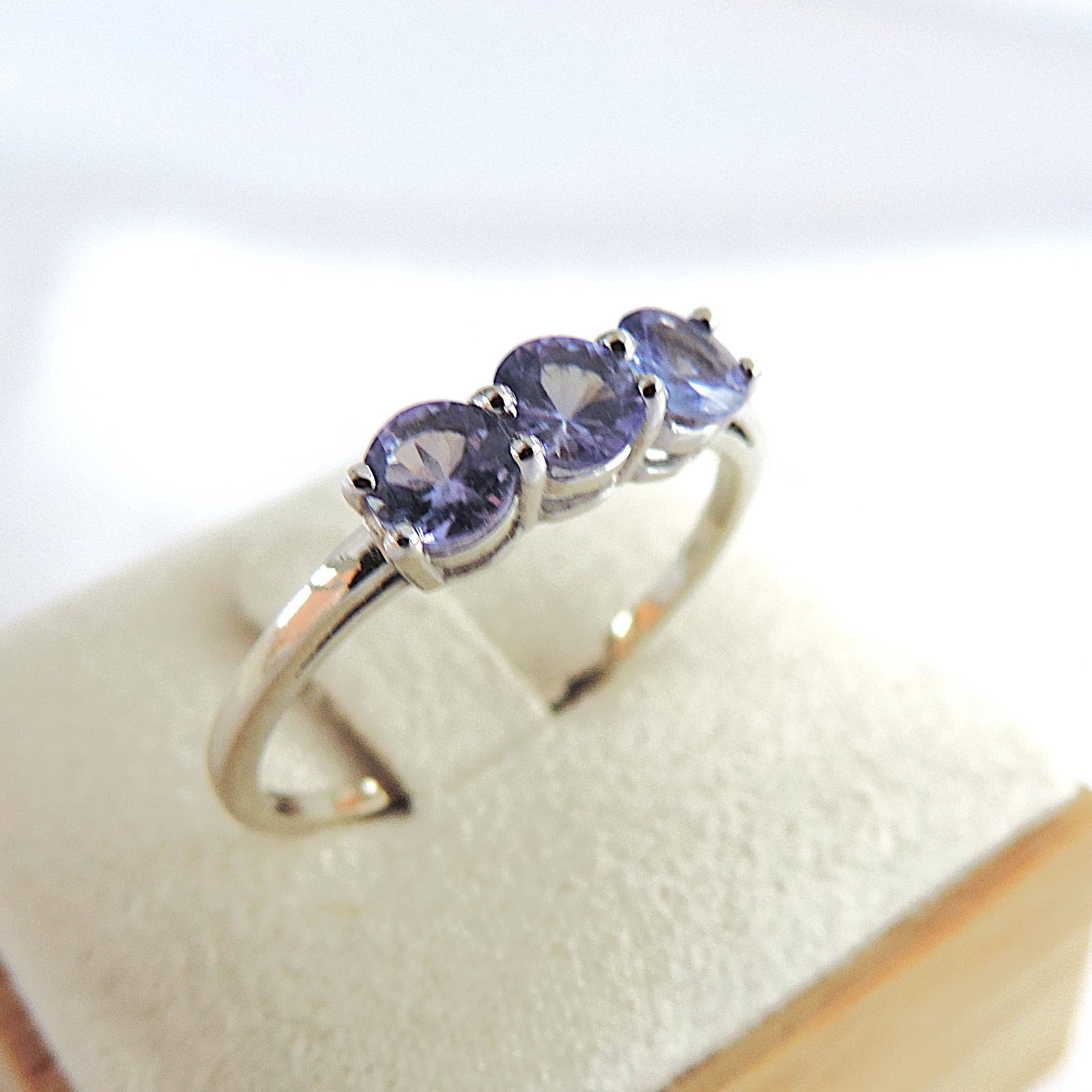 925 Silver Tanzanite Trilogy Gemstone Ring 'New': Title: 925 Silver Tanzanite Trilogy Gemstone Ring 'New' Description: A lovely 925 silver trilogy Tanzanite gemstone ring tanzanite ring with 3 x 4mm round stones (TCW 0.75). Ring size V. Condition: