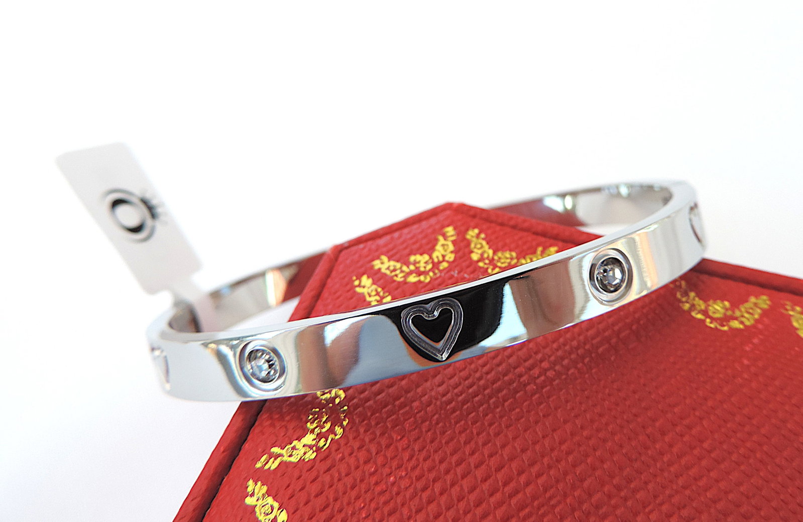 Orrevé White Zircon Love Bracelet 'New': Title: Orrevé White Zircon Love Bracelet 'New' Description: A gorgeous Orrevé polished stainless steel hinged bracelet with sparkling white Zircons. Includes a gift pouch. (Part