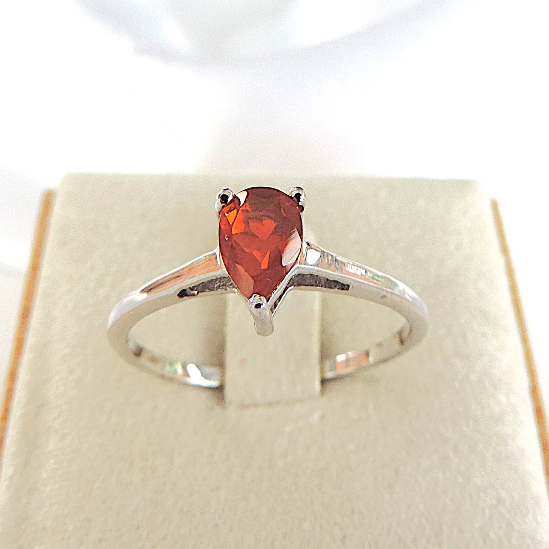 925 Silver Orange AAA Fire Opal Ring 'New': Title: 925 Silver Orange AAA Fire Opal Ring 'New' Description: A lovely 925 silver ring set with a 7x5mm pear shape Orange AAA American Fire Opal. Ring size S. Includes gift pouch