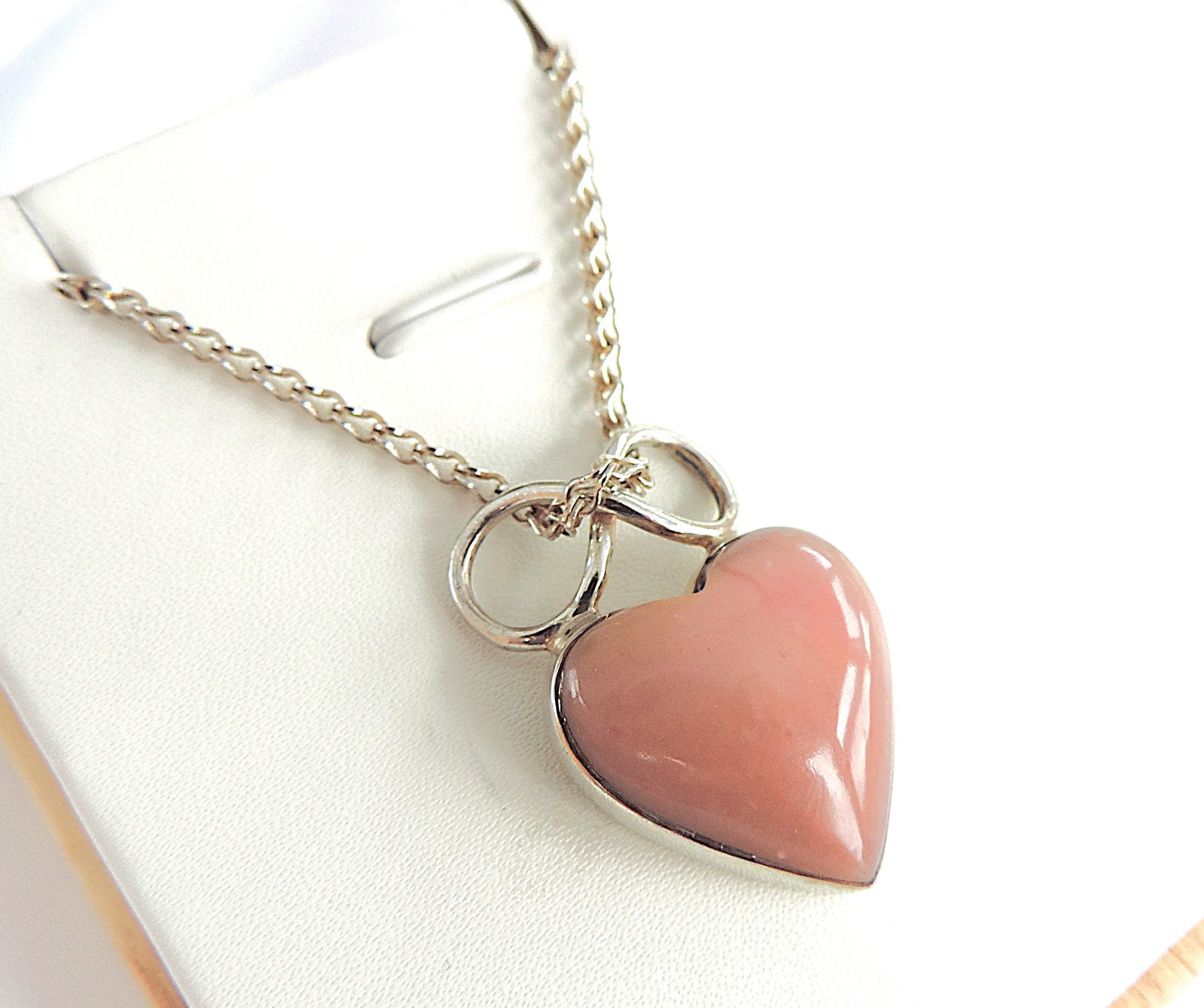 925 Silver Pink Coral Cabochon Heart Gemstone Necklace: Title: 925 Silver Pink Coral Cabochon Heart Gemstone Necklace Description: A lovely 925 silver heart shaped pendant necklace set with a Cabochon Pink Coral gemstone. Stamped 925