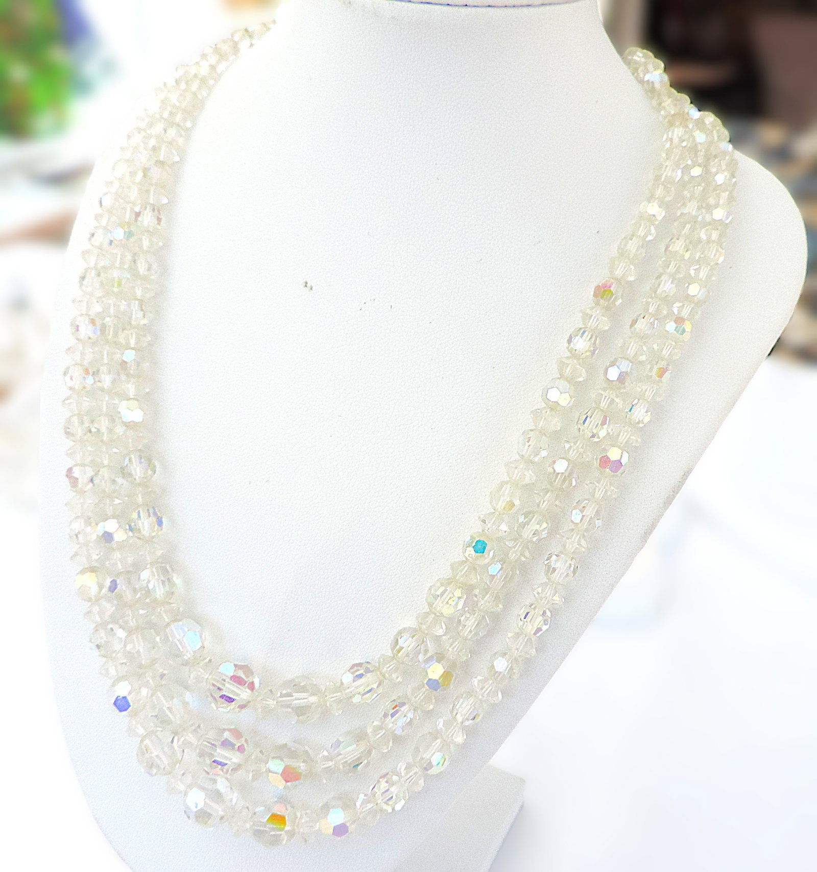 Vintage Three Strand Aurora Borealis Necklace: Title: Vintage Three Strand Aurora Borealis Necklace Description: A beautiful triple strand Aurora Borealis necklace measuring 15.5 to 17.5 inches. Excellent vintage condition. Condition: