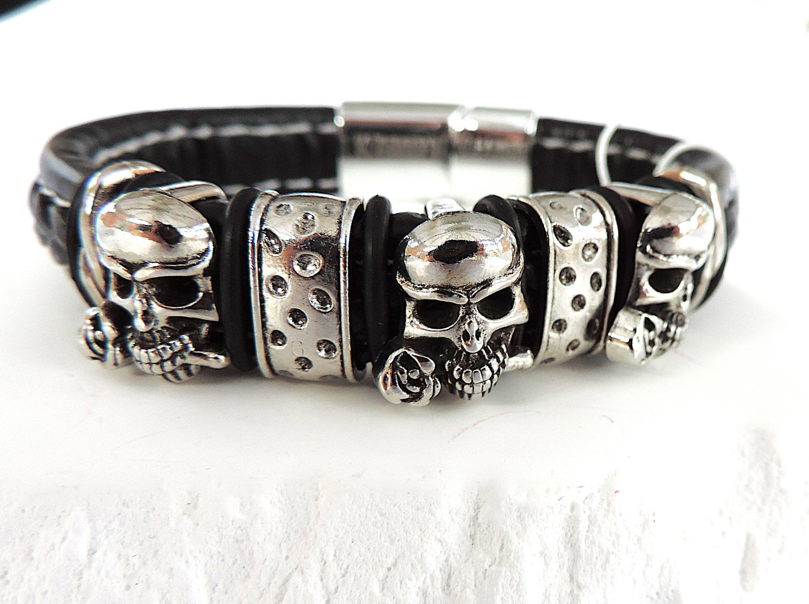 Aethon Black Leather Pirate Skulls Bracelet 'New': Title: Aethon Black Leather Pirate Skulls Bracelet 'New' Description: Aethon black plaited leather triple pirate skulls bracelet. 21cm ( 8.50 inches) long 1.5cm wide. (Part of liquidation stock of a