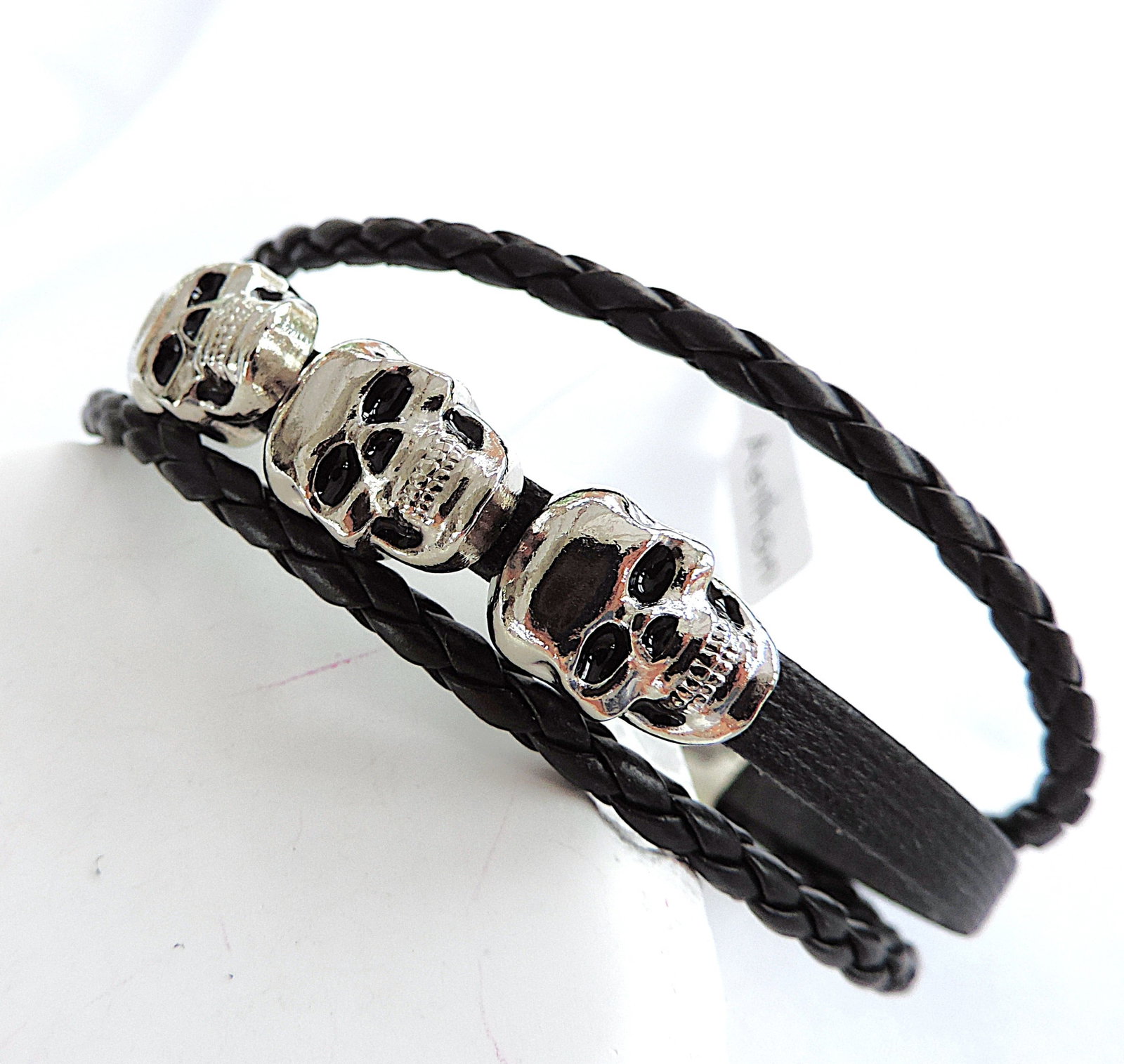Aethon Men's Leather Braided Triple Skull Bracelet 'New': Title: Aethon Men's Leather Braided Triple Skull Bracelet 'New' Description: Black leather stainless steel Aethon braided bracelet with 3 stainless steel skulls. Measurements: 8.5 inches long.