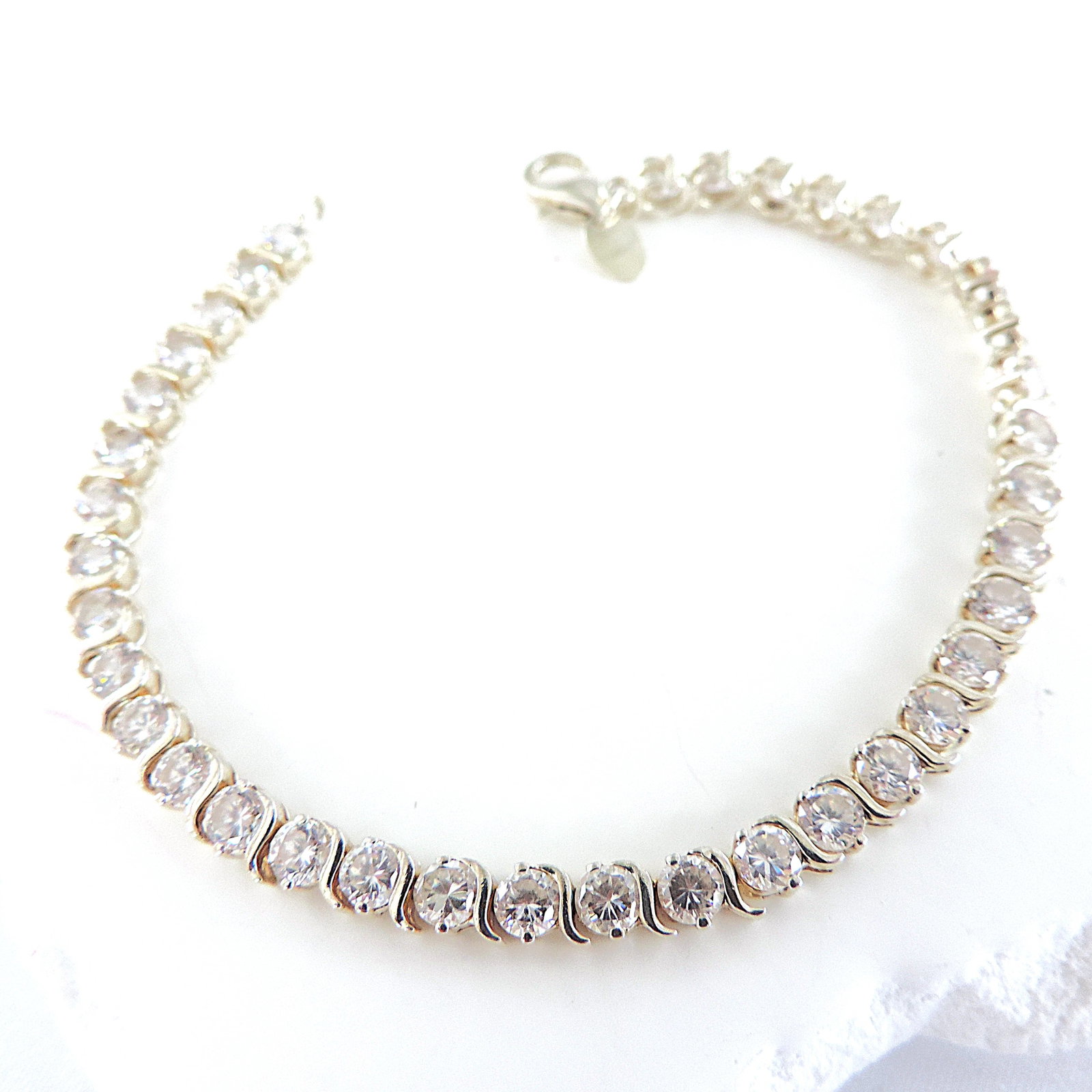 925 Silver 6 Carat CZ GemstoneTennis Bracelet: Title: 925 Silver 6 Carat CZ GemstoneTennis Bracelet Description: A beautiful bracelet in 925 silver set with 37x3mm sparkling CZ gemstones (TCW 6.60). The bracelet measures 7.75 in