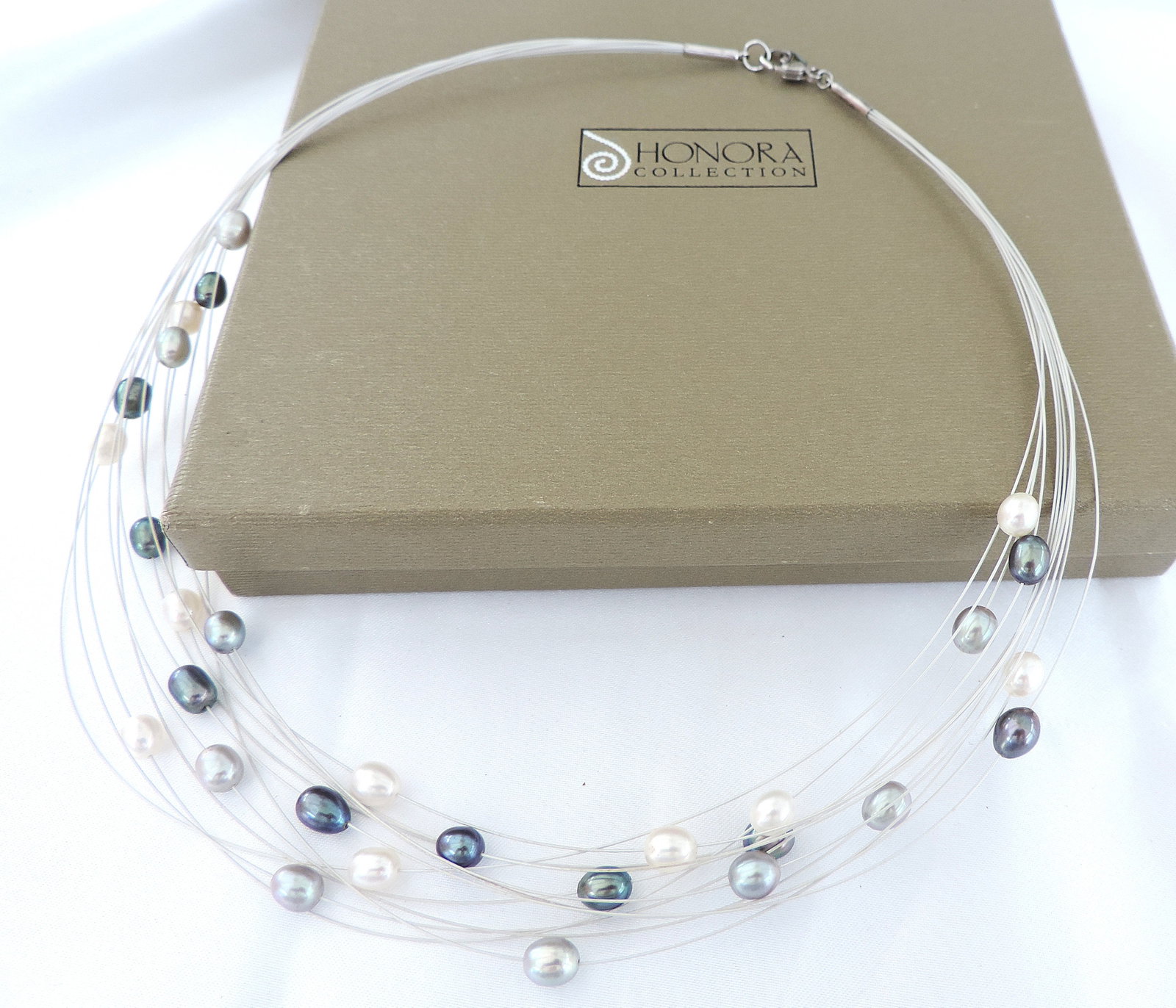 Honora Multi Strand Floating Pearl Necklace 925 Clasp New Boxed: Title: Honora Multi Strand Floating Pearl Necklace 925 Clasp New Boxed Description: A delicate and contemporary necklace by Honora featuring multiple fine silver tone wire strands, each accented with