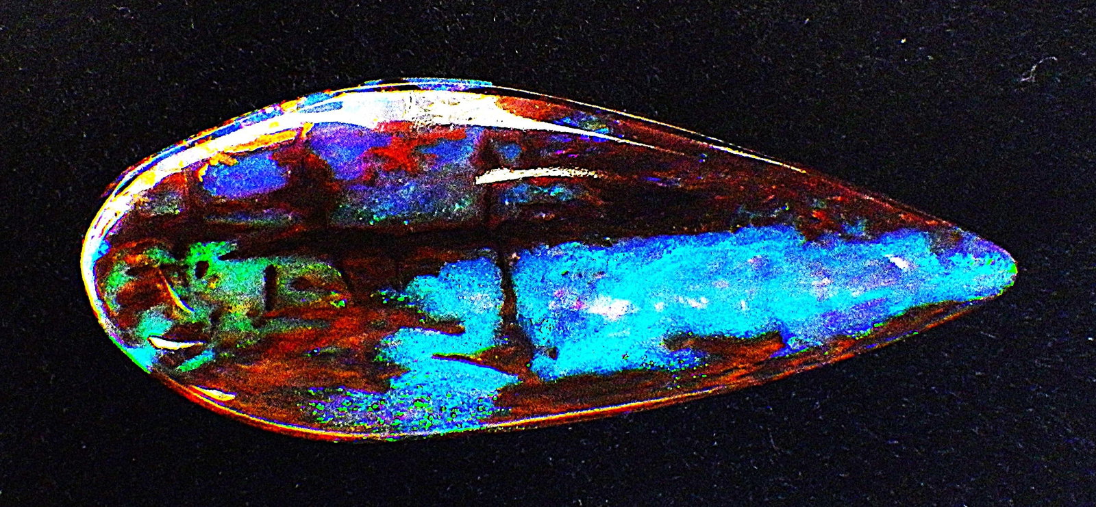 Rare Australian black opal fossil wood 20 carats: Title: Rare Australian black opal fossil wood 20 carats Description: A spectacular and rarely seen in such quality and size black opal fossil wood with wonderful blue hues. Highly polished, tear drop