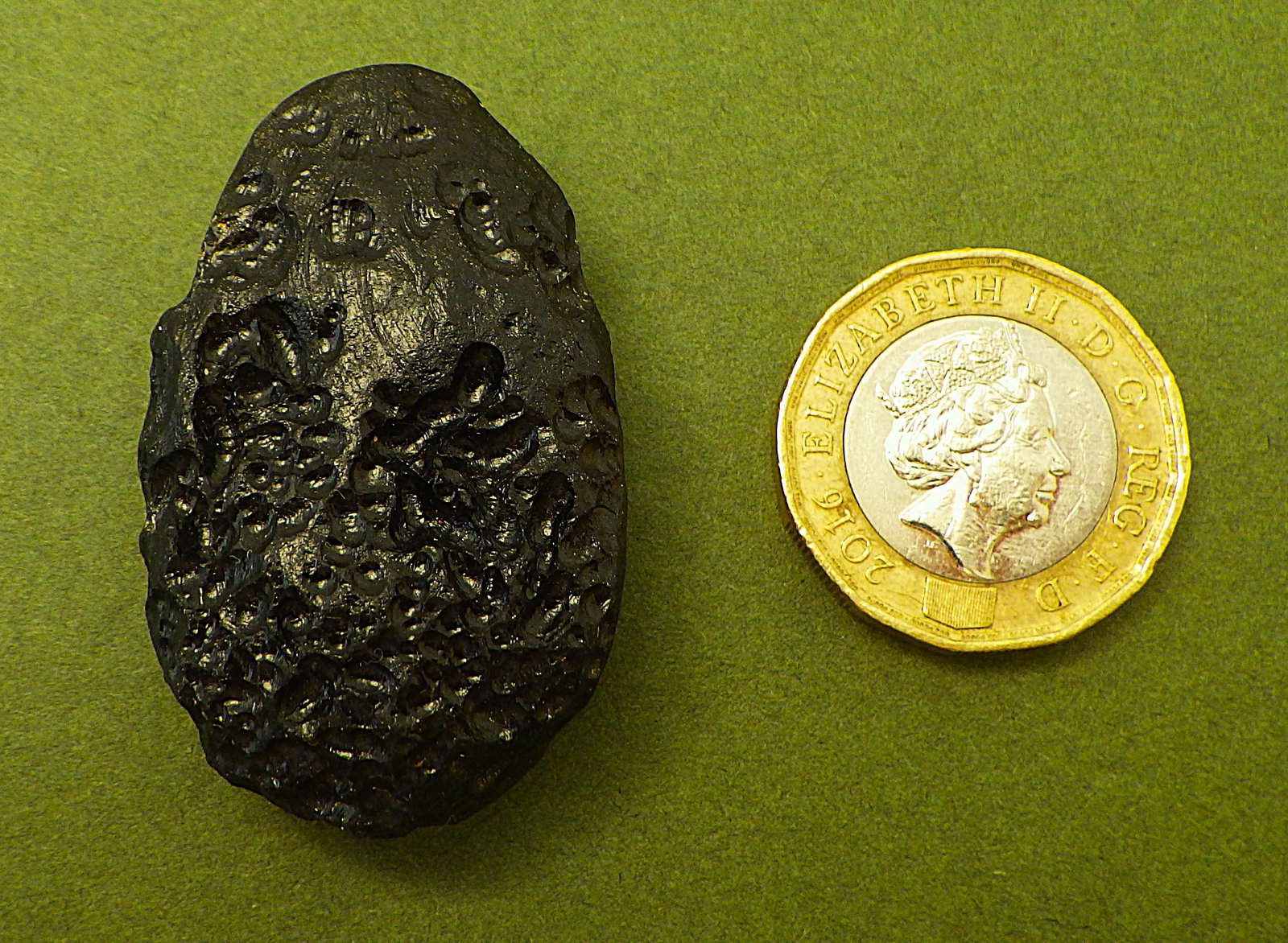 Natural complete Tektite from Philippines: Title: Natural complete Tektite from Philippines Description: A natural, complete Tektite from Philippines. Good pitting, uniform black colour (as expected), dimensions 42 x 26 x 16 mm, weight: 21 g.