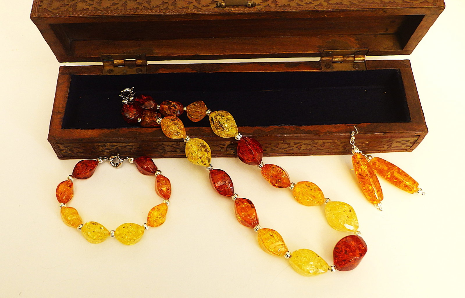 A vintage amber resin necklace, bracelet & earrings set in a wooden ornate box.: Title: A vintage amber resin necklace, bracelet & earrings set in a wooden ornate box. Description: A stunning and very substantial, vintage, multi-coloured, amber resin, necklace, bracelet and