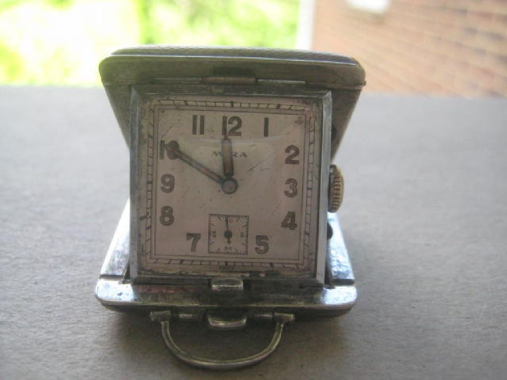 Vintage Mira EPNS Miniature Travelling Clock: Title: Vintage Mira EPNS Miniature Travelling Clock Description: Vintage Mira EPNS Cased Miniature Travel Clock. Dates to around 1940. Length is 1.5 Inches. Condition: Good. Clock is Fully Working.