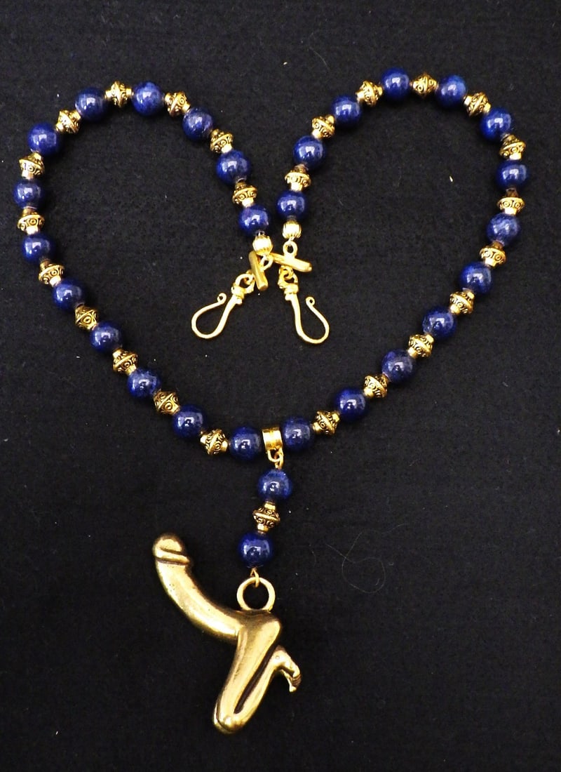 A vintage lapis lazuli necklace with bronze fertility symbol: Title: A vintage lapis lazuli necklace with bronze fertility symbol Description: A very rare, vintage, lapis lazuli necklace with a bronze pendant fertility symbol and bronze hand made spacer beads.
