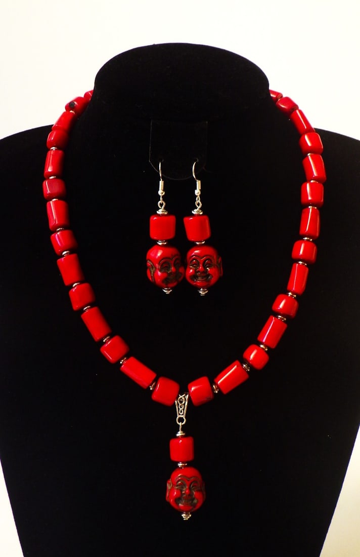 Buddhist red coral necklace & earrings set: Title: Buddhist red coral necklace & earrings set Description: A substantial, chunky, red coral necklace and earrings set with smiling Buddha head pendants. Necklace length: 49 cm, earrings