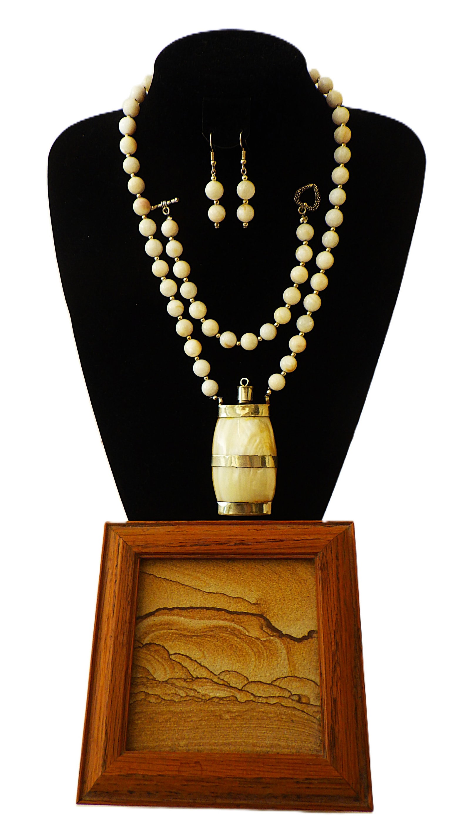 A pilgrim's M.O.P. set in a wooden presentation box: Title: A pilgrim's M.O.P. set in a wooden presentation box Description: A vintage mother of pearl necklace with a miniature bottle pendant to carry Holly Water as worn by pilgrims to the Holly Land