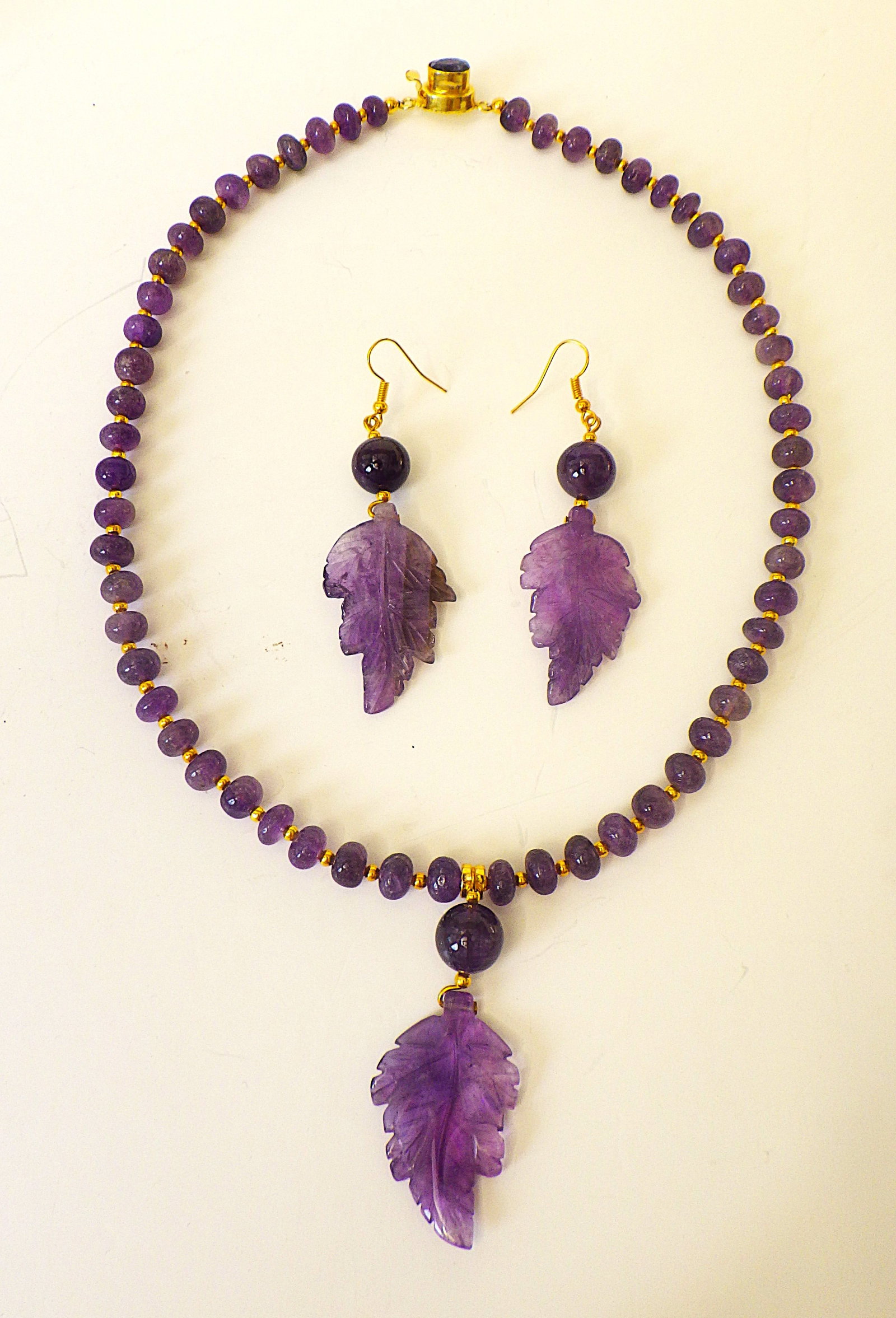 Amethyst necklace & earrings set with hand carved leaves: Title: Amethyst necklace & earrings set with hand carved leaves Description: A very special natural Brazilian amethyst necklace and earrings set with exquisitely hand carved leaf pendants, in a