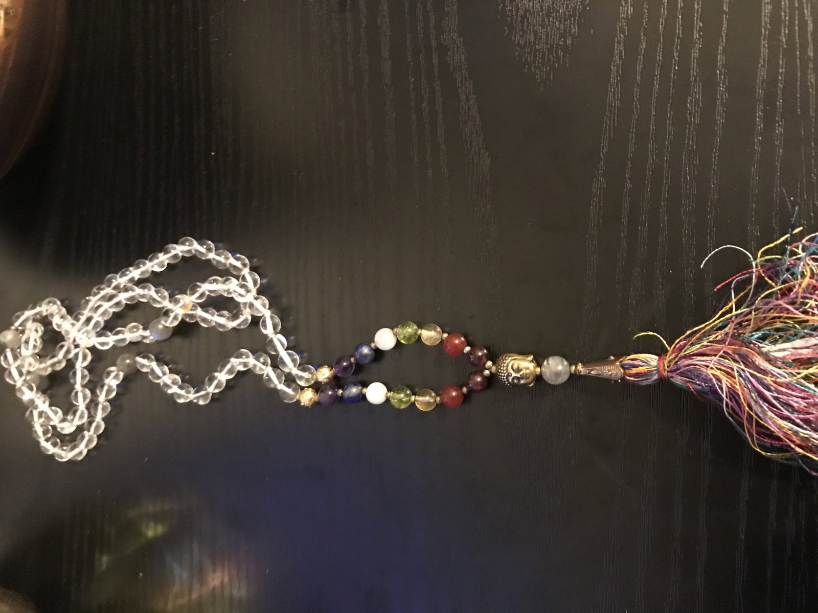 Clear Quartz Long Bead Necklace With Buddha Charm and Tassle: Title: Clear Quartz Long Bead Necklace With Buddha Charm and Tassle Description: Clear quartz polished beads long Necklace/ Mala with semi-precious stones. Centered with a Buddha cha