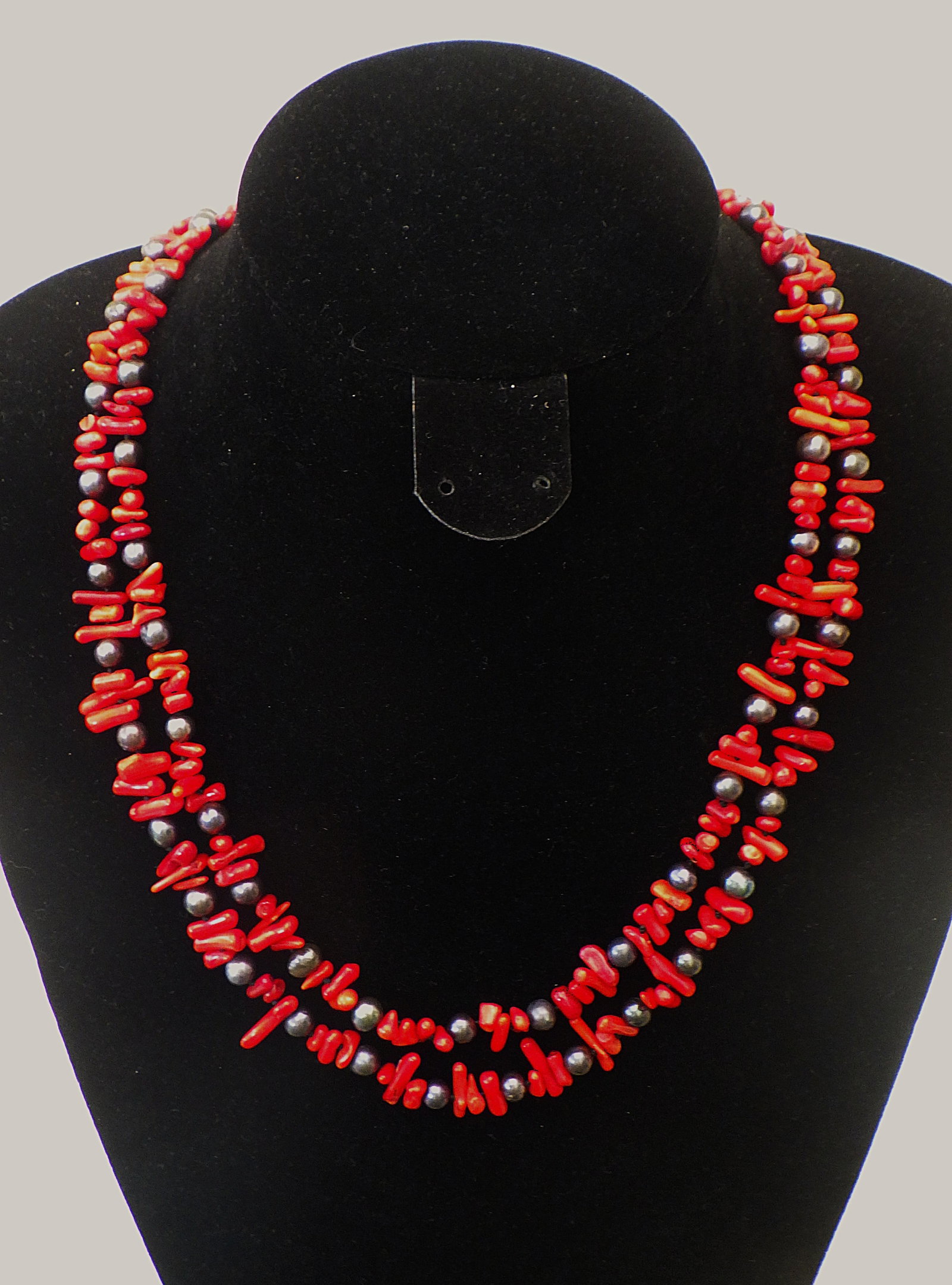 Two strand red coral and natural black pearl necklace: Title: Two strand red coral and natural black pearl necklace Description: A beautiful and very feminine two row necklace with red coral and genuine black cultured pearls. Length: 50 cm. Very
