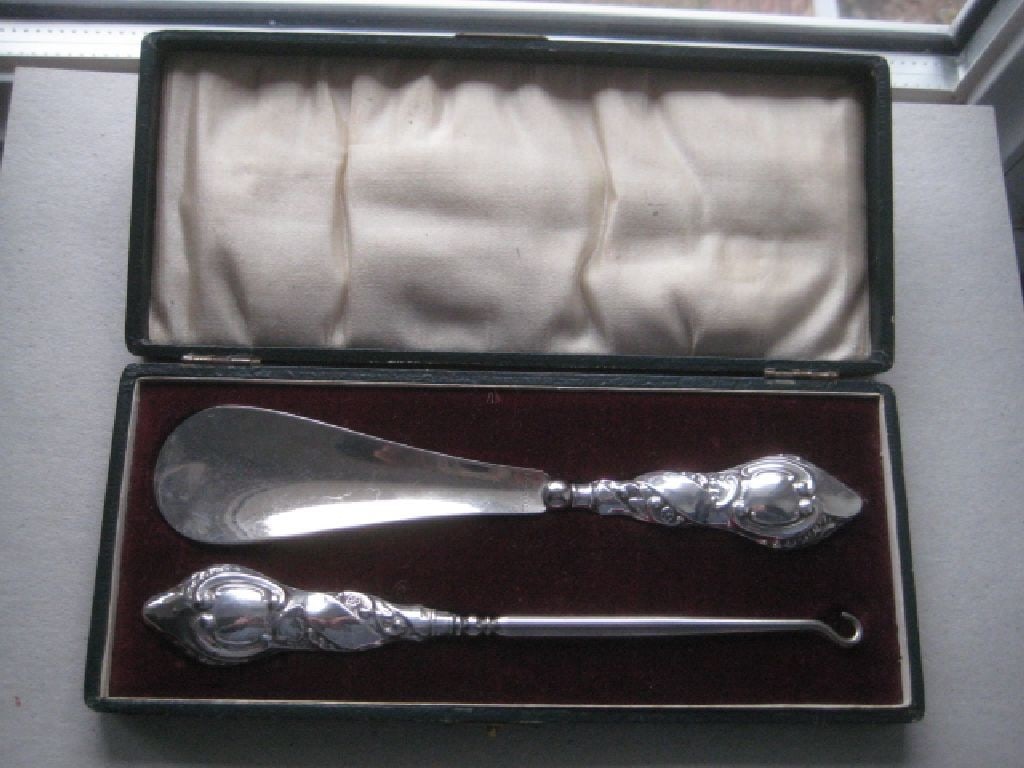 Edwardian Silver Shoehorn and Buttonhook Set, Cased: Title: Edwardian Silver Shoehorn and Buttonhook Set, Cased Description: The Handles Are Engraved With Floral Decoration. In Original Leather Case. Hallmarked For Chester 1908 And Made By Joseph And
