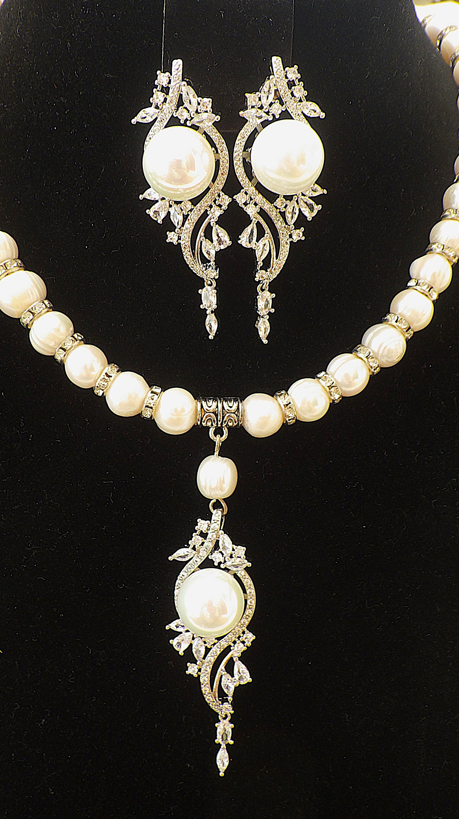 Glamorous natural white pearl necklace & earrings set with fancy pendants with CZ: Title: Glamorous natural white pearl necklace & earrings set with fancy pendants with CZ Description: A highly glamorous necklace and earrings set with natural white cultured pearls. The set has long