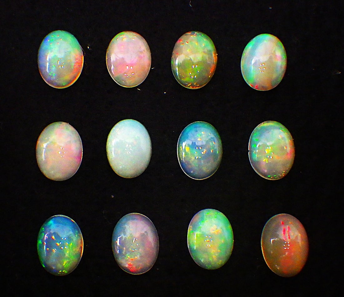 Twelve quality Australian opal cabochons: Title: Twelve quality Australian opal cabochons Description: Twelve, top quality, natural, oval, opal cabochons from Australia. Total weight: 12.25 carats. Dimensions (each): 9 x 7 x 2.5 mm (appr.)