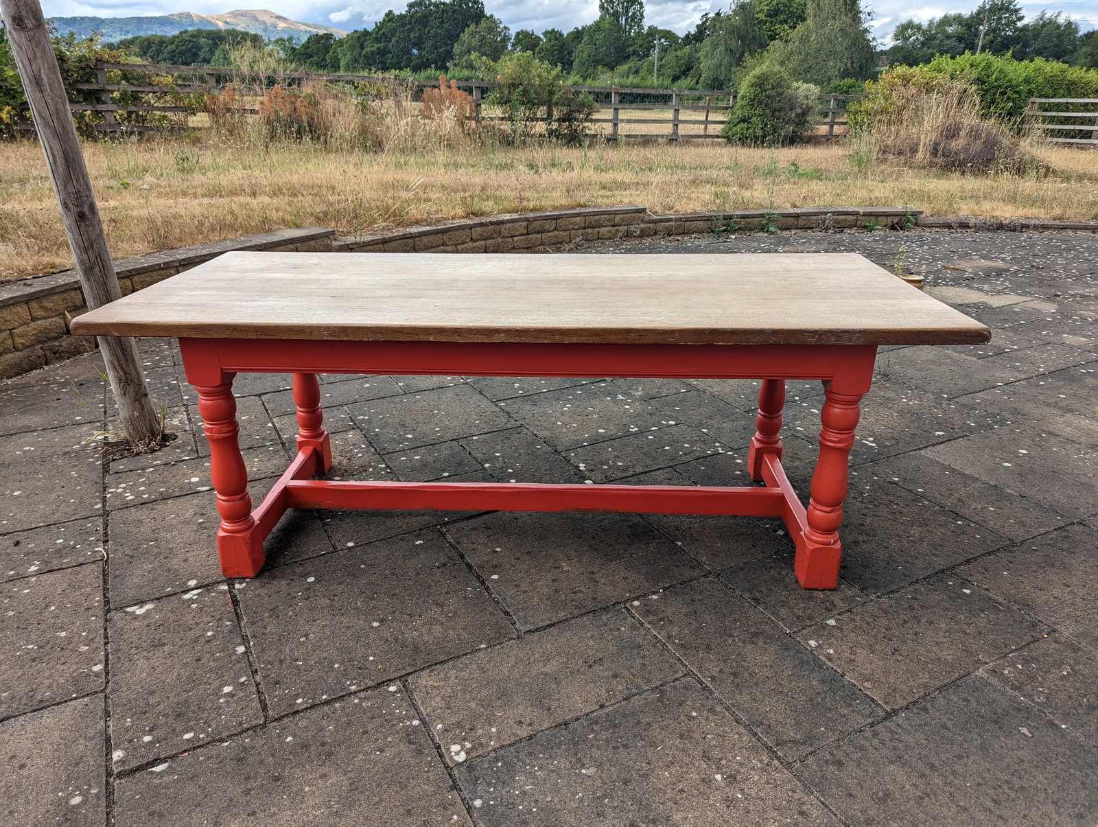 A striking vintage farmhouse dining table: Title: A striking vintage farmhouse dining table Description: A striking vintage farmhouse dining table that marries rustic warmth with bold personality. At 7 feet long, its substantial solid oak top