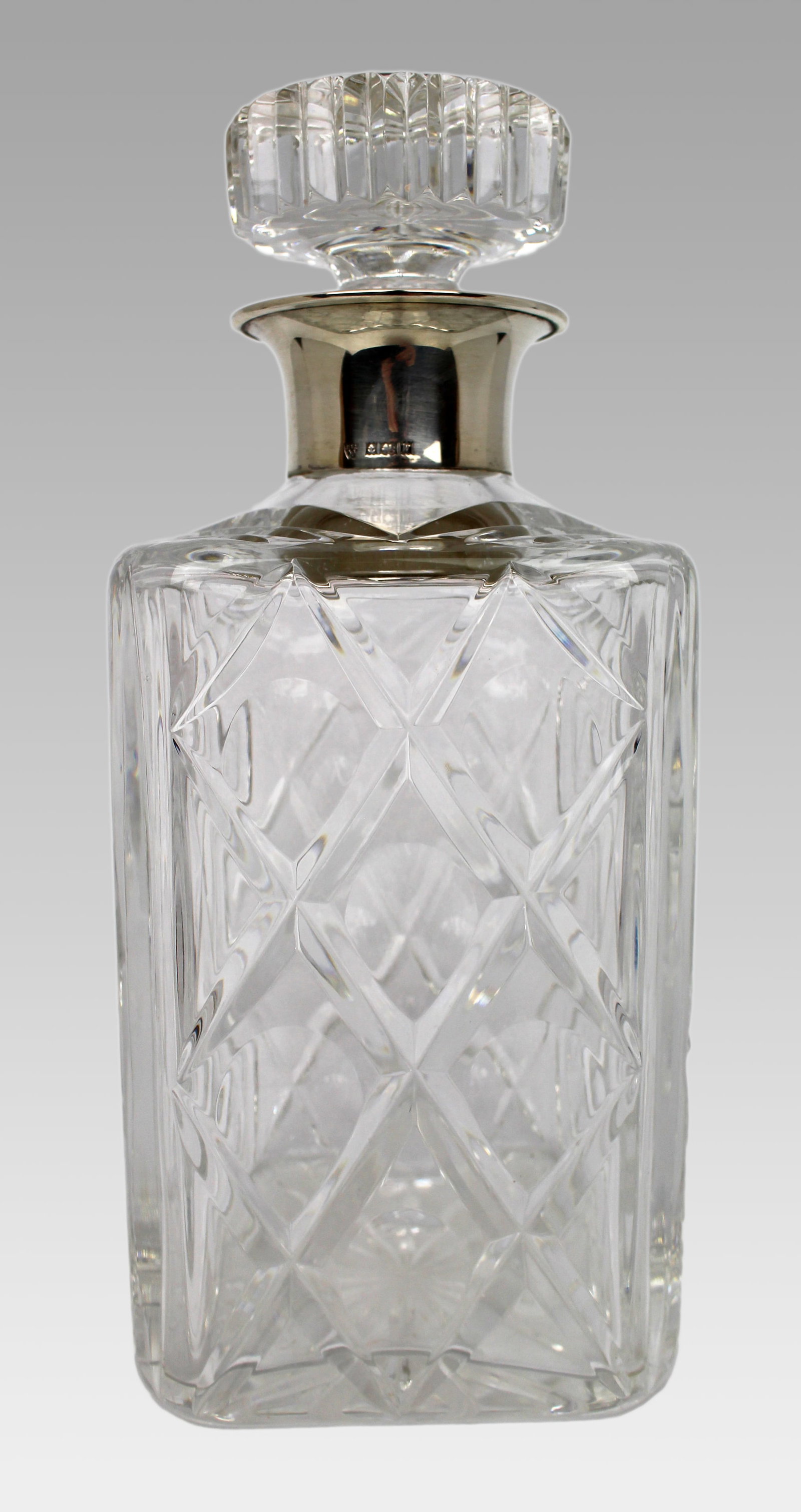 Title: Cut Glass Silver Mounted Decanter Description: Cut Glass Silver Mounted Decanter. Measures 10: Title: Cut Glass Silver Mounted Decanter Description: Cut Glass Silver Mounted Decanter. Measures 10 x 10 x 23 (height) cm. Heavy hand cut crystal. Solid silver mount, fully hallmarked. Very good