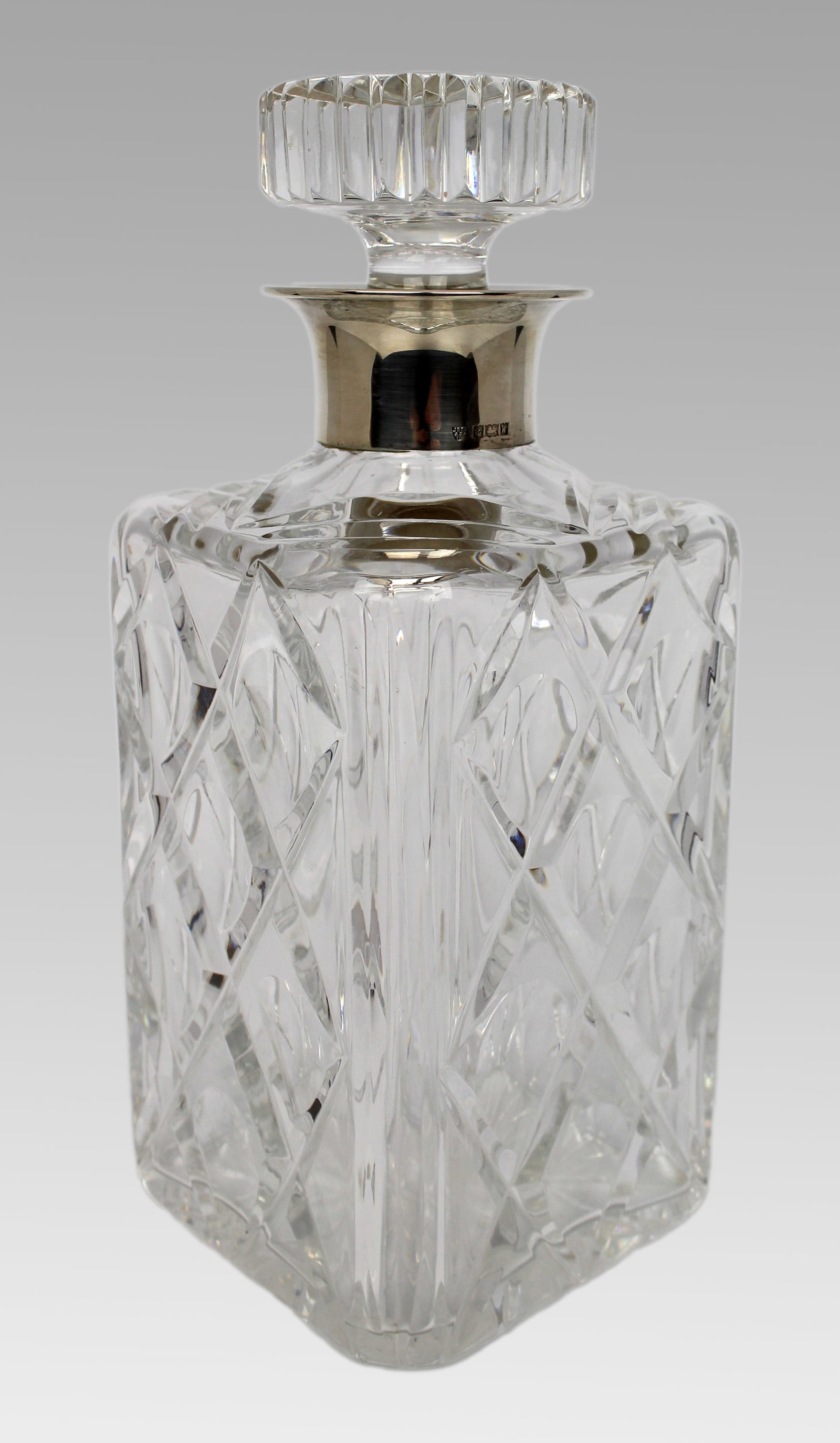 Title: Cut Glass Silver Mounted Decanter Description: Cut Glass Silver Mounted Decanter. Measures 10 - 4
