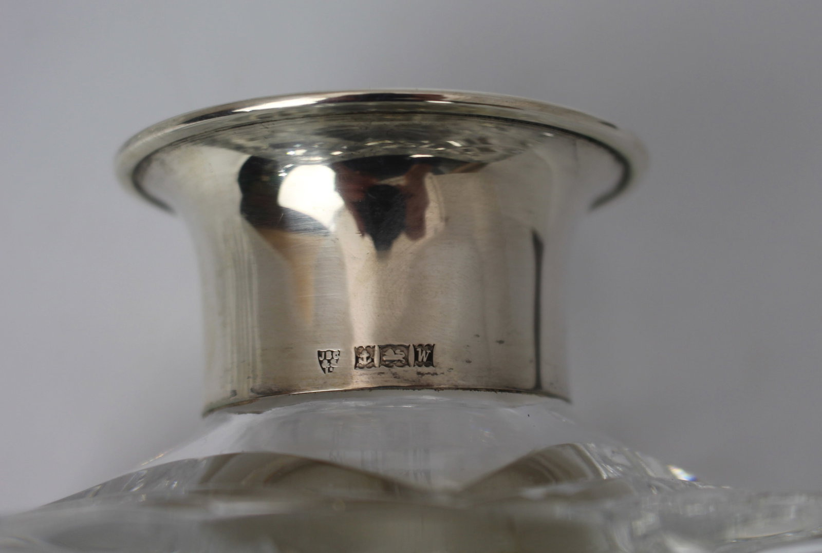 Title: Cut Glass Silver Mounted Decanter Description: Cut Glass Silver Mounted Decanter. Measures 10 - 6