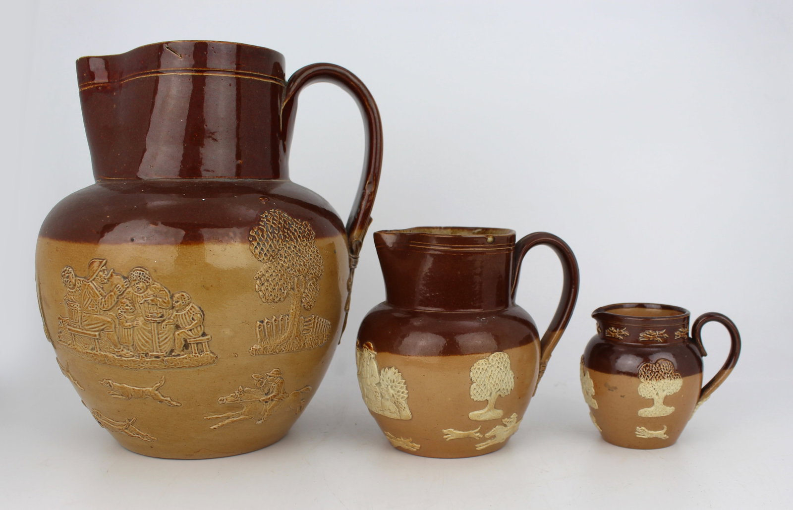 Title: Collection of Three Graduated Doulton Lambeth Stoneware Jugs, c.1900 Description: Set of - 19