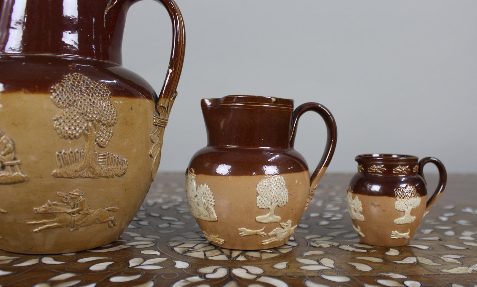 Title: Collection of Three Graduated Doulton Lambeth Stoneware Jugs, c.1900 Description: Set of - 3