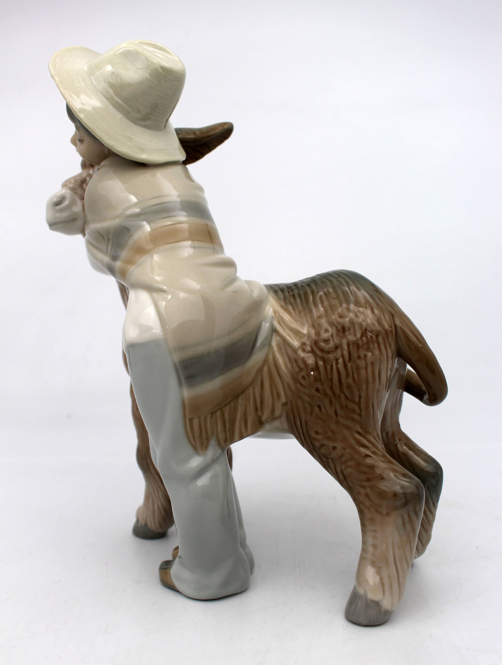 Title: Lladro Boy Hugging Donkey Description: Lladro Boy Hugging Donkey Measures 15 x 10 x 21 ( - 6