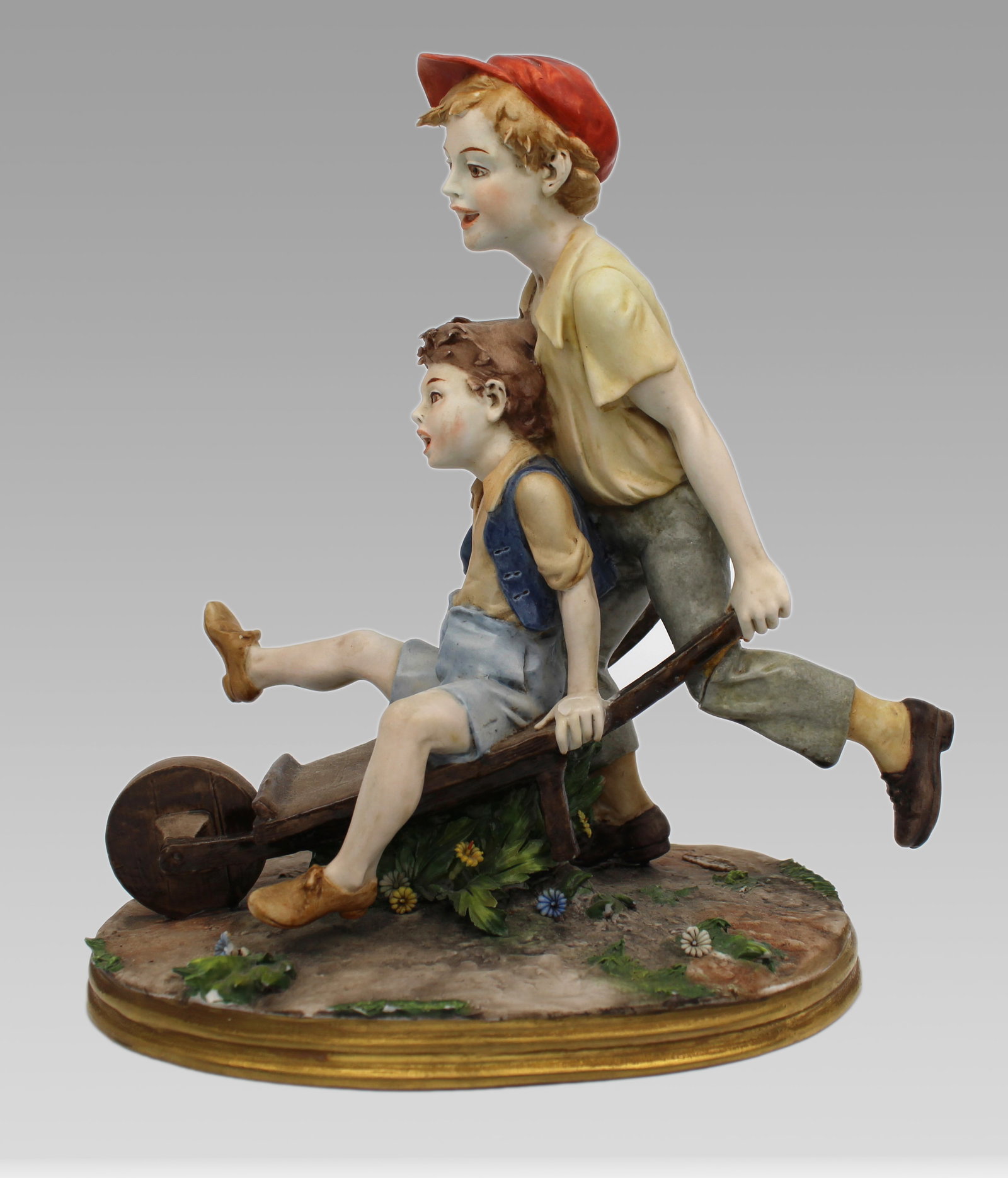 Title: Capodimonte Figurine Boys in Wheelbarrown by Bernacchio Description: Capodimonte Figurine: Title: Capodimonte Figurine Boys in Wheelbarrown by Bernacchio Description: Capodimonte Figurine Boys in Wheelbarrown by Bernacchio Made in Italy, c.1970. Finely modelled with lots of detail; richly