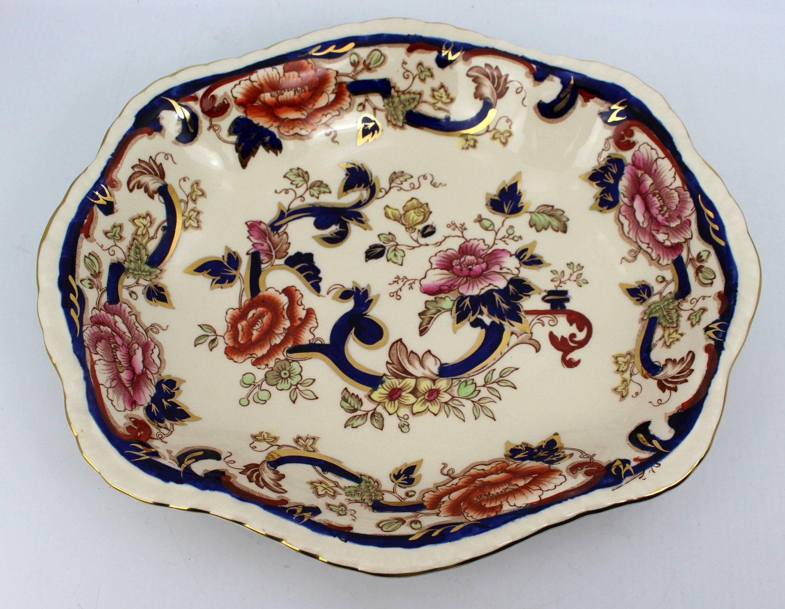 Title: Mason's Mandalay Serving Bowl Description: Measures 28 x 24 x 4.5 cm. Small stress fracture: Title: Mason's Mandalay Serving Bowl Description: Measures 28 x 24 x 4.5 cm. Small stress fracture to outside beneath rim), few scratches in align with age. Cobalt a very brilliant colour. Condition: