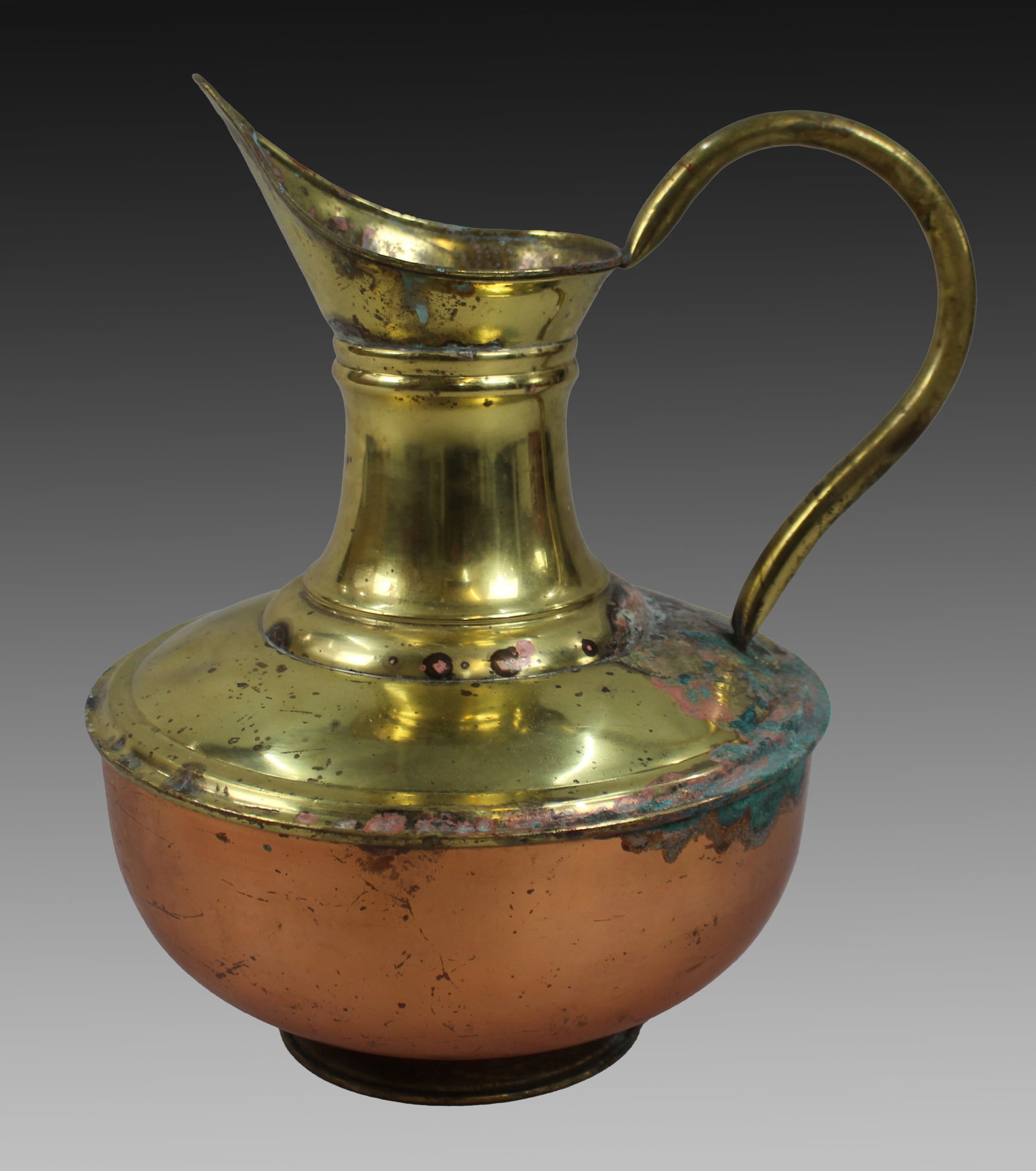 Title: Vintage Copper & Brass Ewer Description: Vintage Copper & Brass Ewer A large and decorative: Title: Vintage Copper & Brass Ewer Description: Vintage Copper & Brass Ewer A large and decorative vintage copper and brass ewer with an elegant curved handle and flared spout. Likely mid-20th