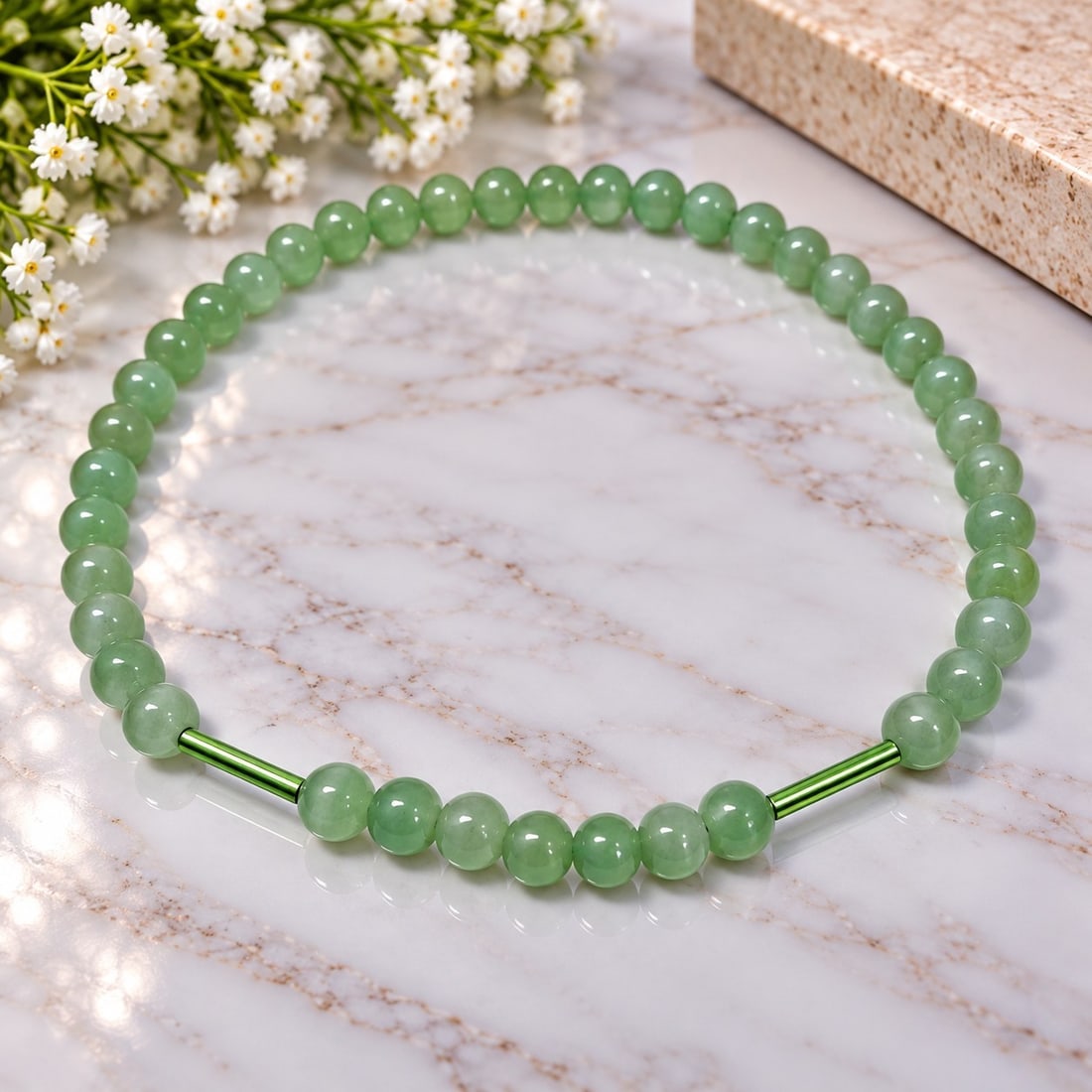 Green Beaded Necklace with Metallic Accents: Title: Green Beaded Necklace with Metallic Accents Description: Elegant necklace featuring polished pale green round beads with two metallic green accent sections. A simple contemporary design with a