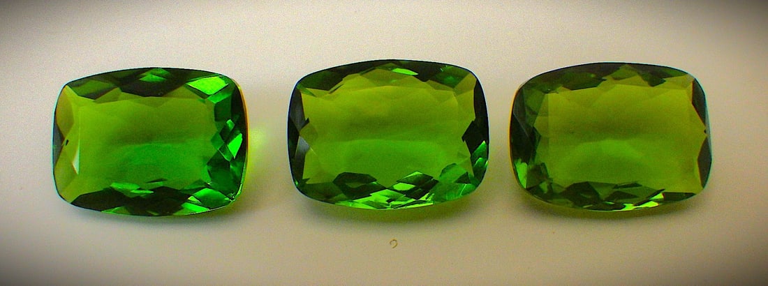Three Radiant Cut Peridots 50 Carats (Total): Title: Three Radiant Cut Peridots 50 Carats (Total) Description: Three lovely, radiant cut peridots, simulated (man made) with excellent colour saturation and uniformity, in excellent