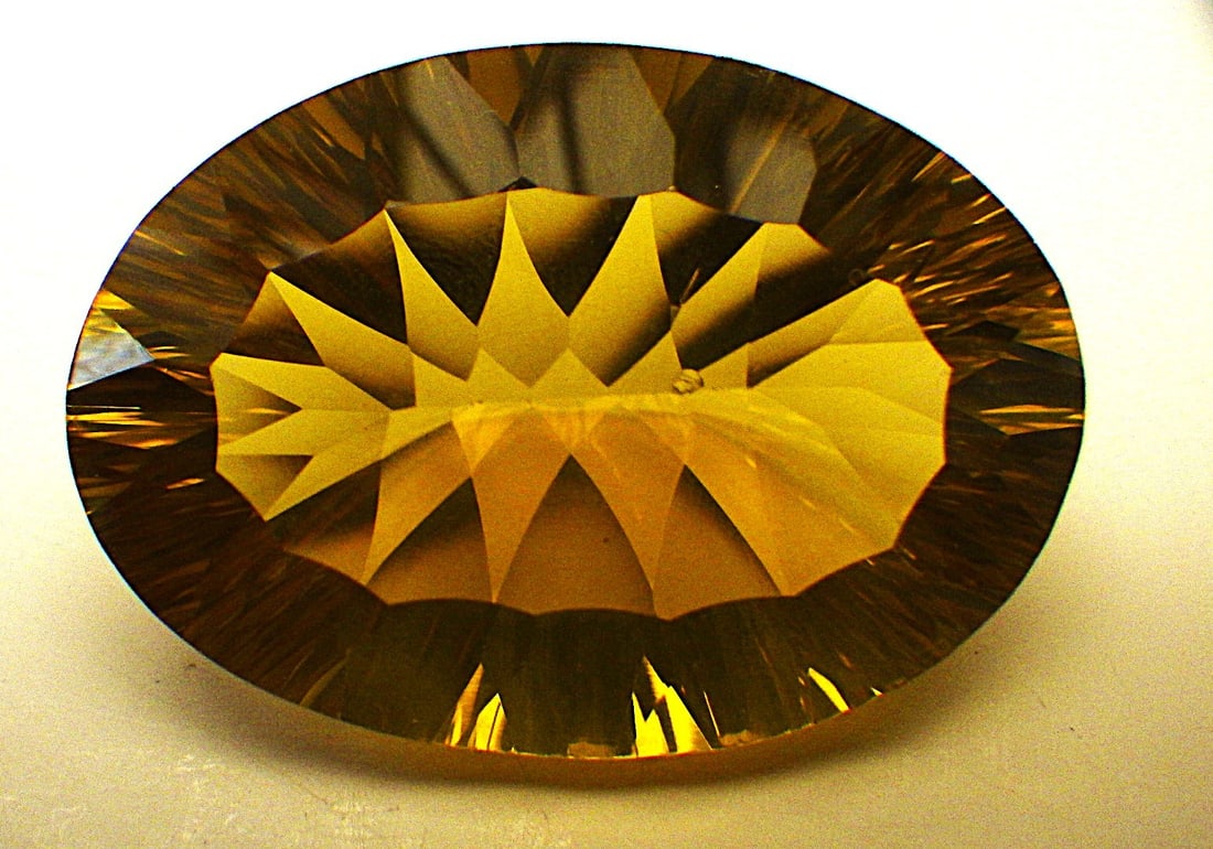 Custom Oval Cut Citrine 60 Carats: Title: Custom Oval Cut Citrine 60 Carats Description: A beautiful, large (60 carats), custom oval cut Citrine. Excellent & uniform colour saturation in hues of yellow to light olive