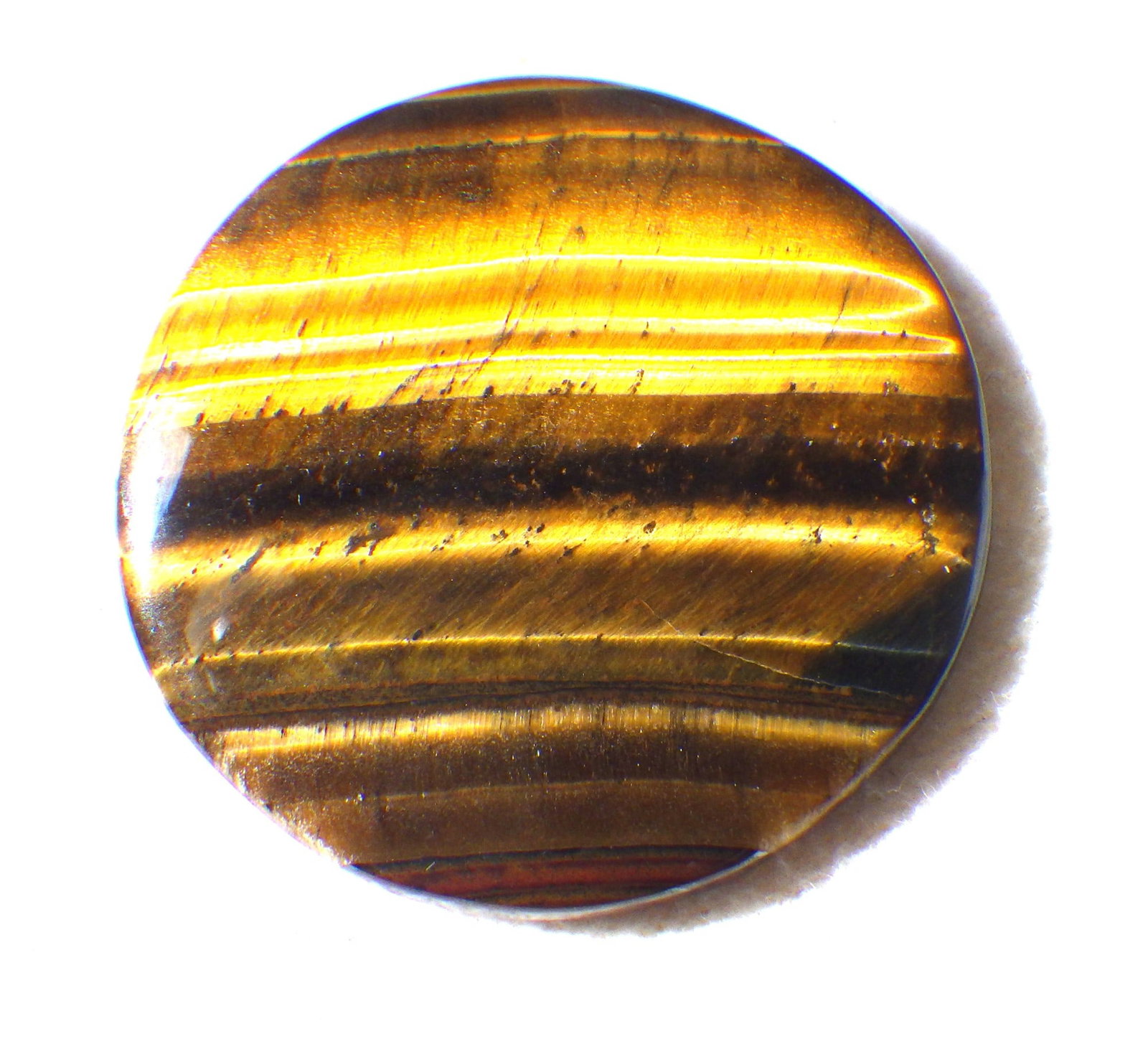 Natural Tiger's Eye Round Cabochon 50 Carats: Title: Natural Tiger's Eye Round Cabochon 50 Carats Description: A stunning, natural Tiger's eye round cabochon, dimensions: 35 x 35 x 3 mm, weight: 50 carats, origin: India. Perfect for jewellery