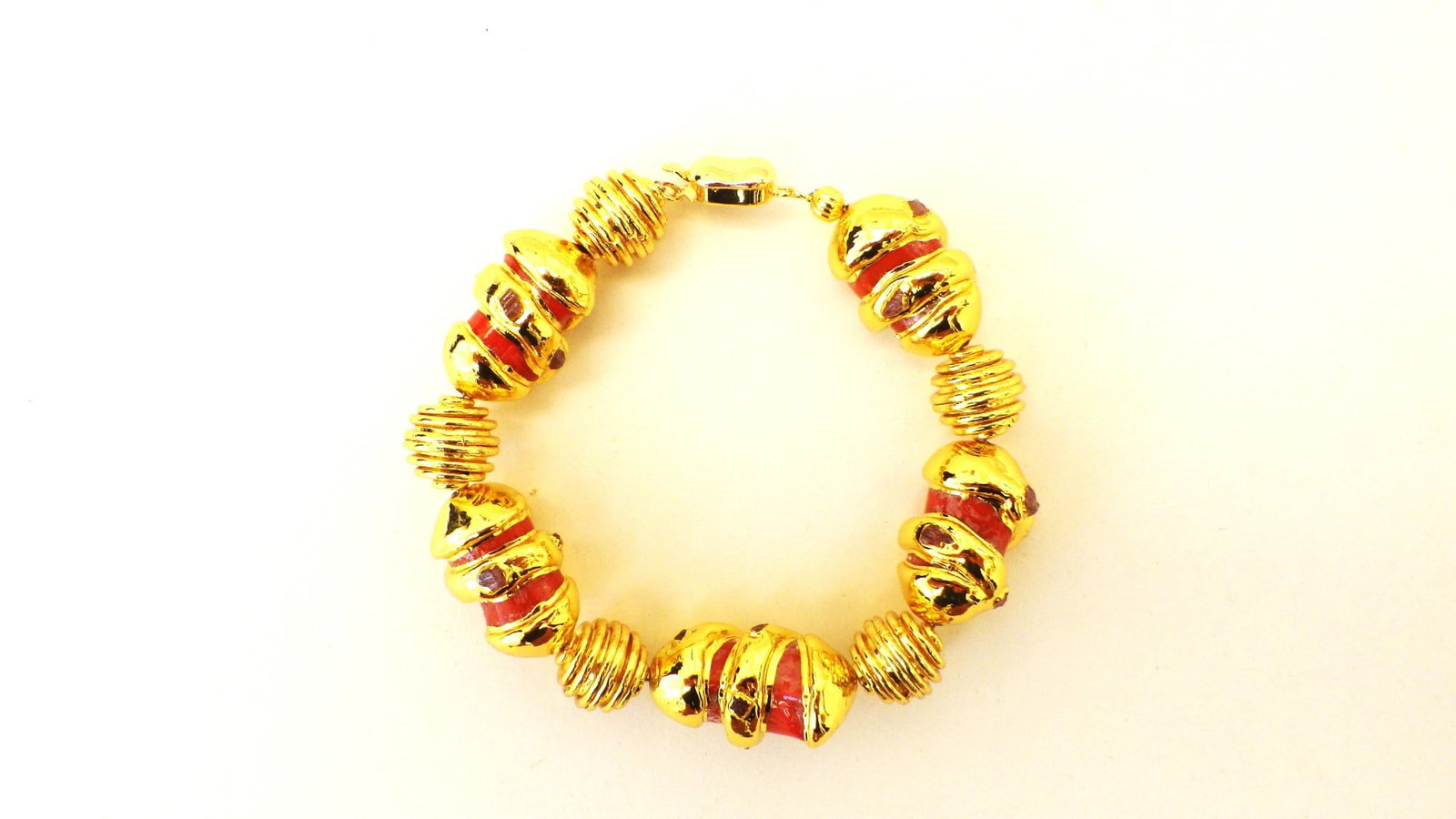 14 K Yellow Gold Plated Red Coral Bracelet: Title: 14 K Yellow Gold Plated Red Coral Bracelet Description: A highly glamorous 14 K yellow gold plated red coral bracelet, highlighted with natural tourmaline crystals in a presentation box. 