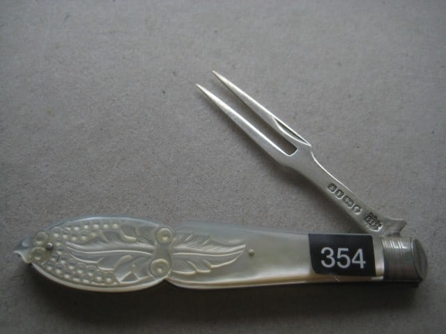 Victorian Mother of Pearl Hafted Silver Folding Fruit Fork: Title: Victorian Mother of Pearl Hafted Silver Folding Fruit Fork Description: Victorian Mother of Pearl Hafted Silver Bladed Folding Fruit Fork. The handle is highly carved wi